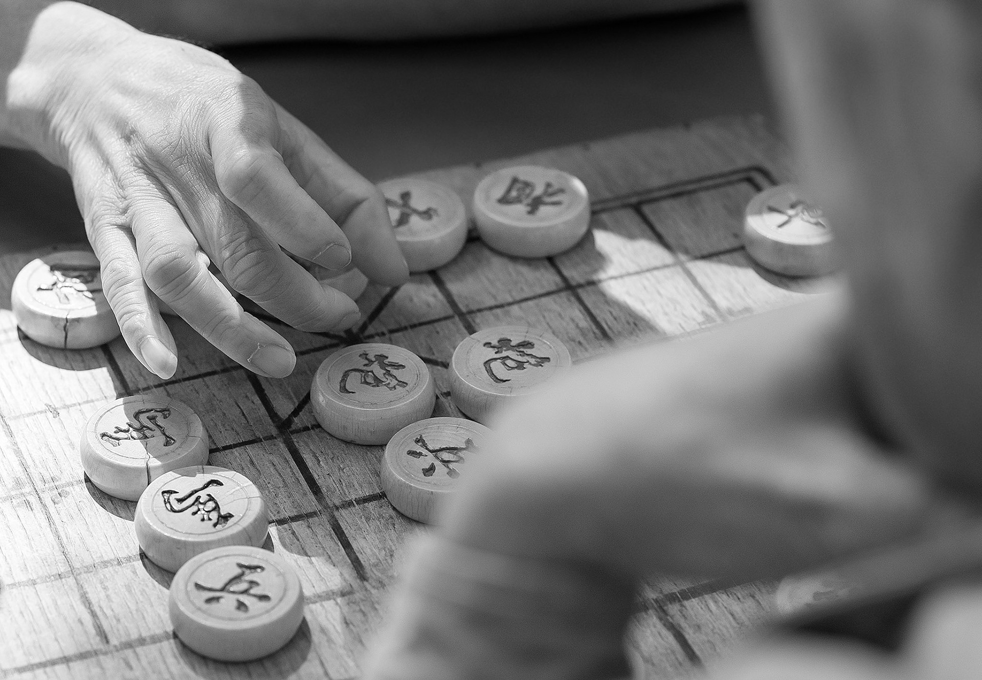 Community members play Mahjong outside on park tables of China Town in Boston.