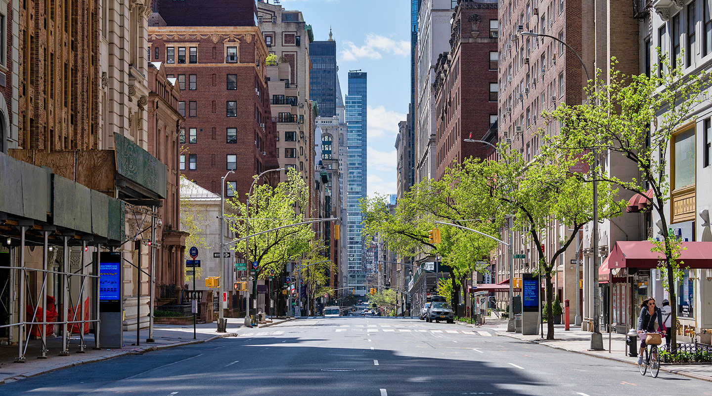 Lone woman on bike riding along Madison Ave during COVID19 lockdown in NYC.