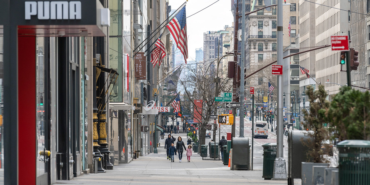 Family walks along an empty 5th ave sidewalk during COVID19 lock down in NYC