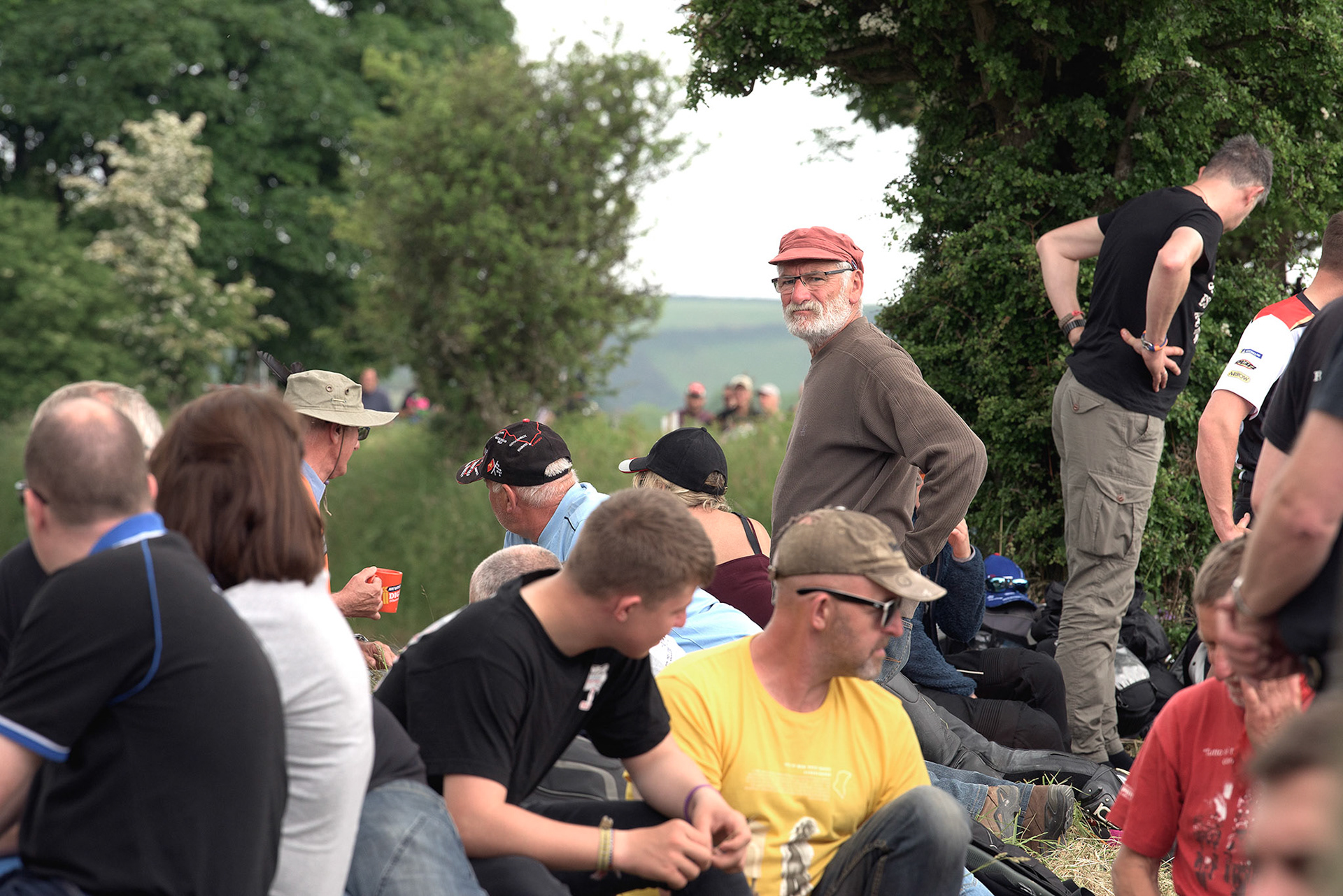 Isle of Man TT fans line the sides of the course and await their hero’s turning round the bend