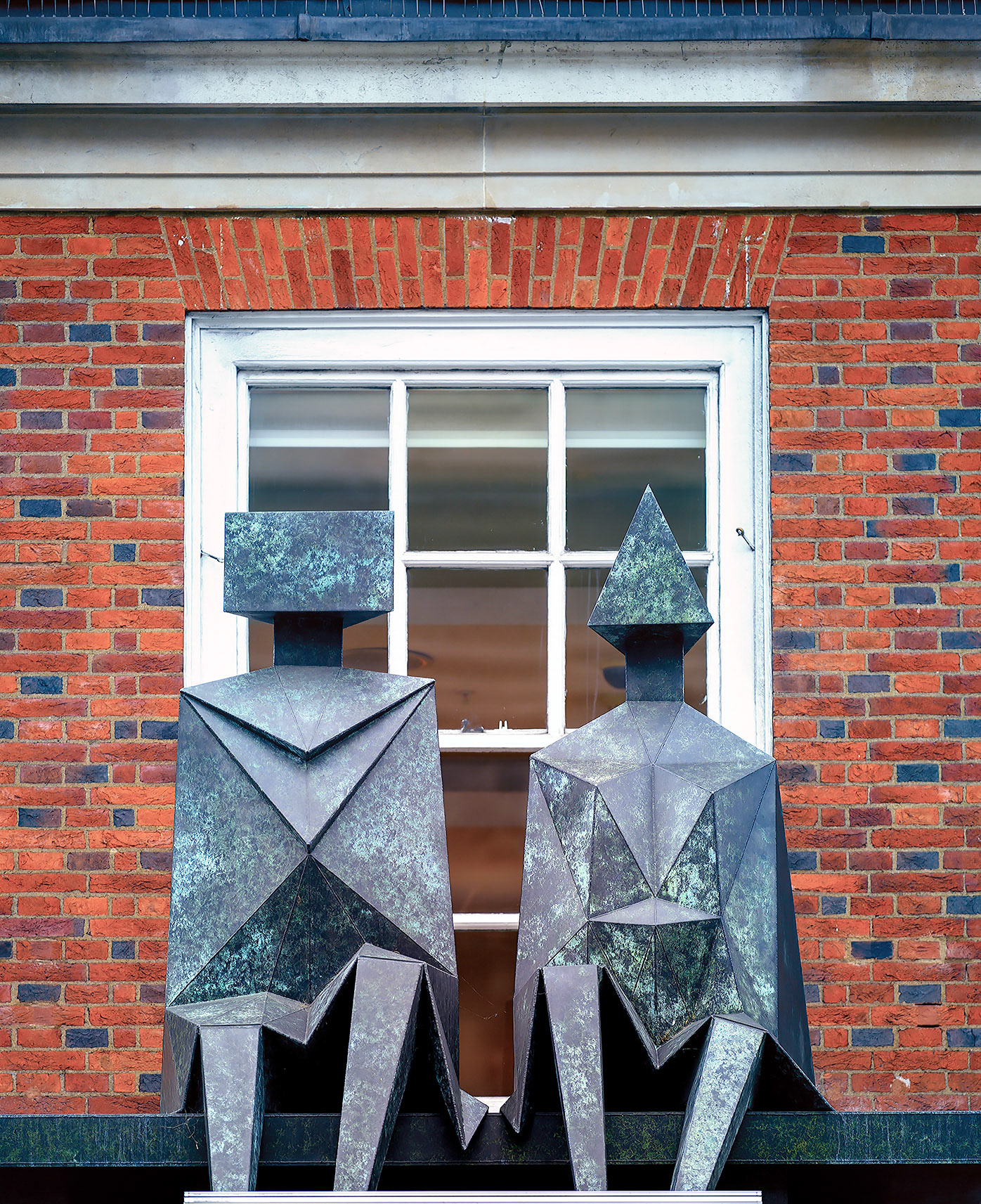 Sculpture on building along Picadilly St., London