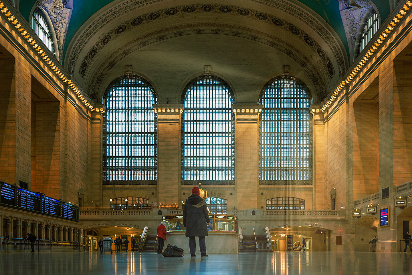 Grand Central Station main hall with only 8 people and sun streaming thru glass