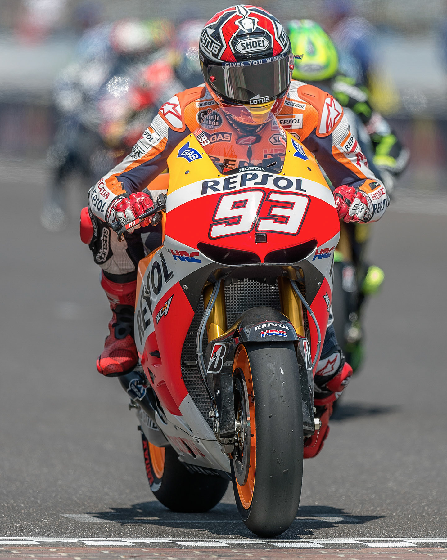 Marc Marquez gets his foot up and throttle open at the start of another MotoGP race.