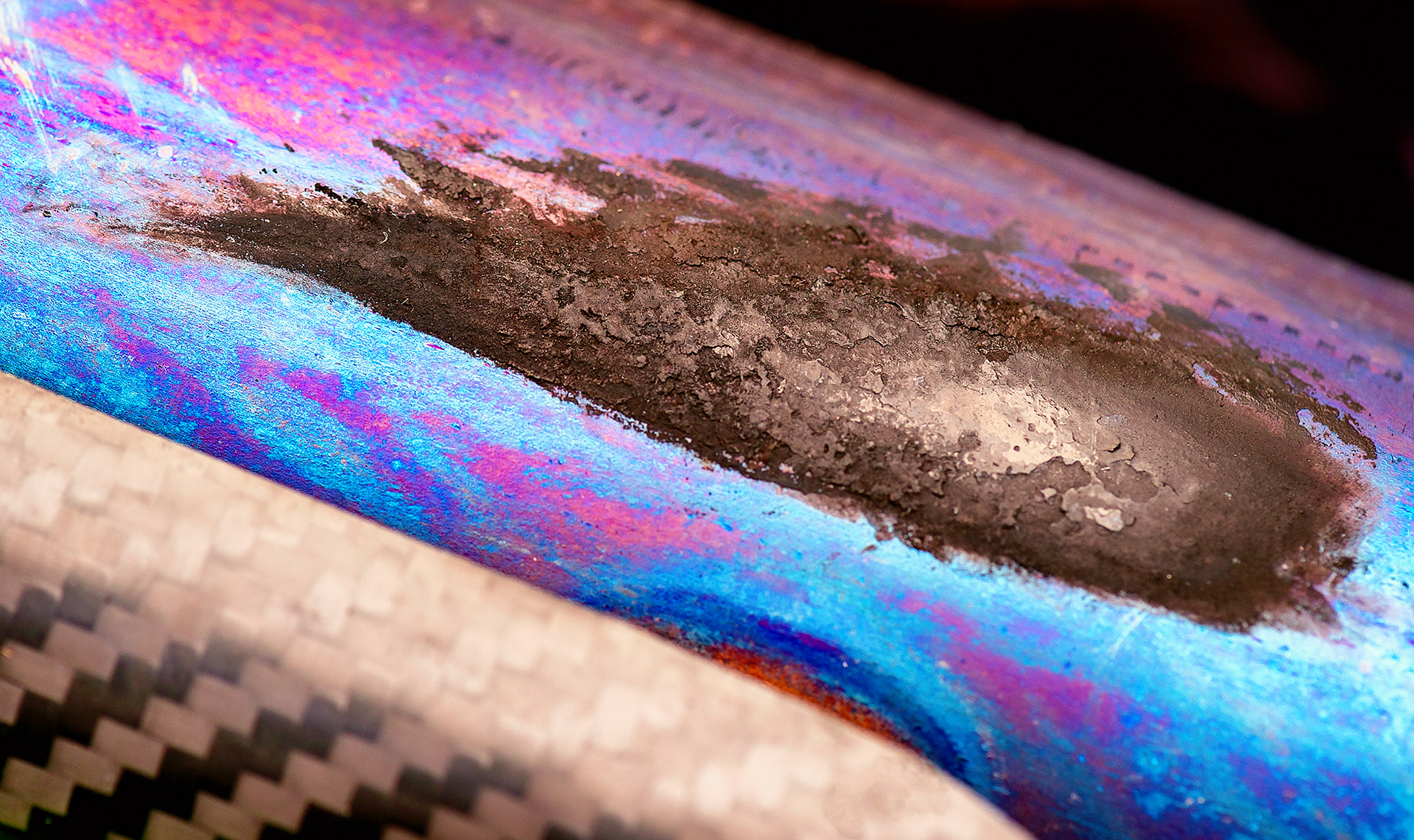 Charred boot rubber on exhaust pipe