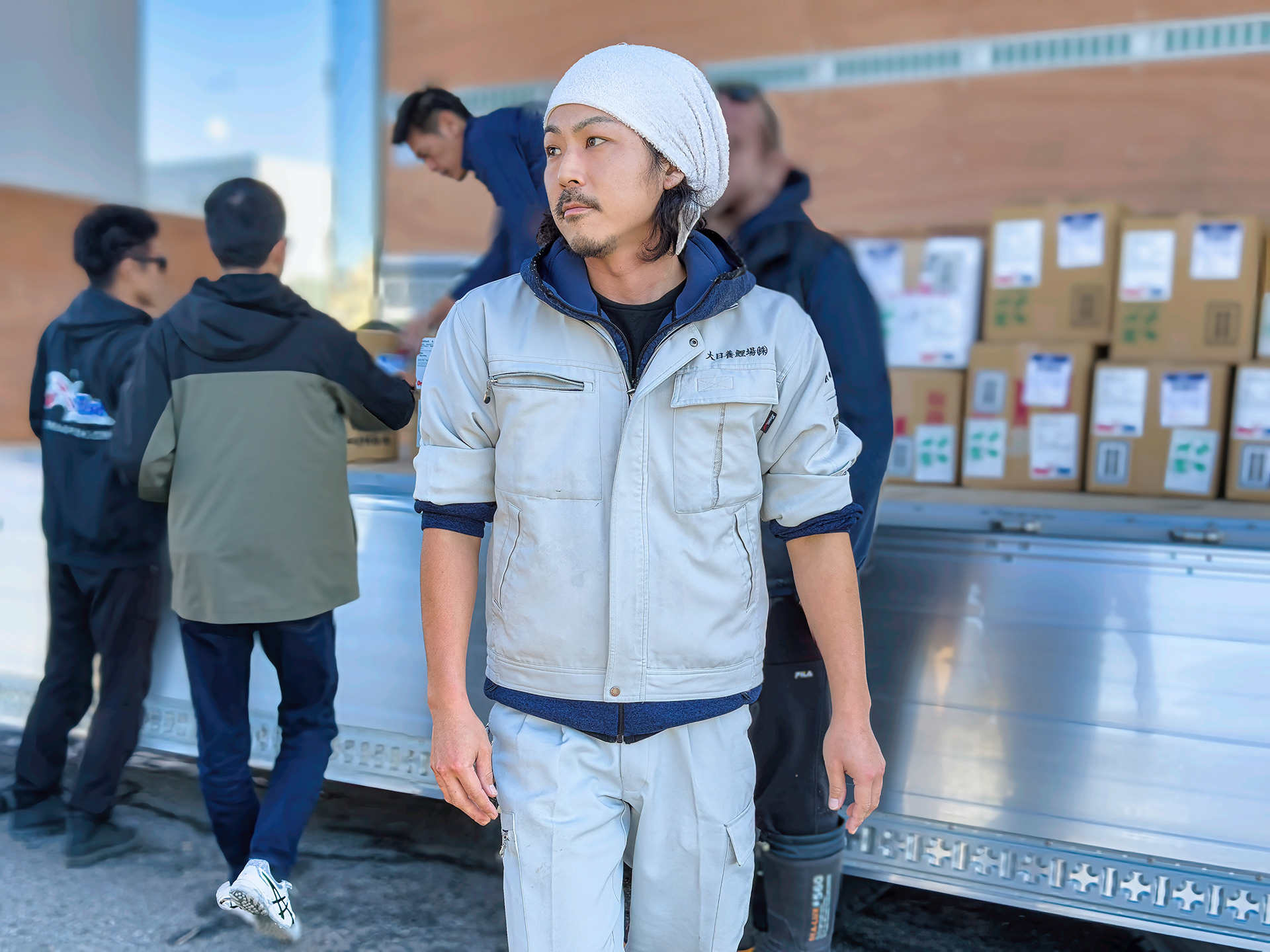 A koi farm employee leaving the loading site 