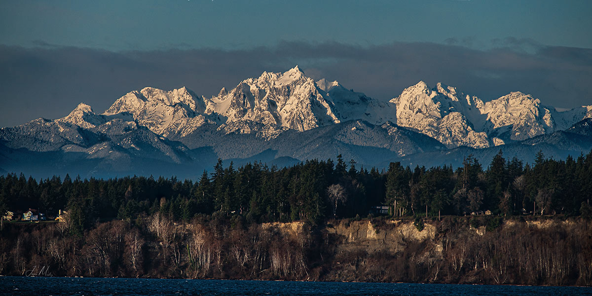 Early morning sun over the Olympic National Park mountains from the Puget Sound