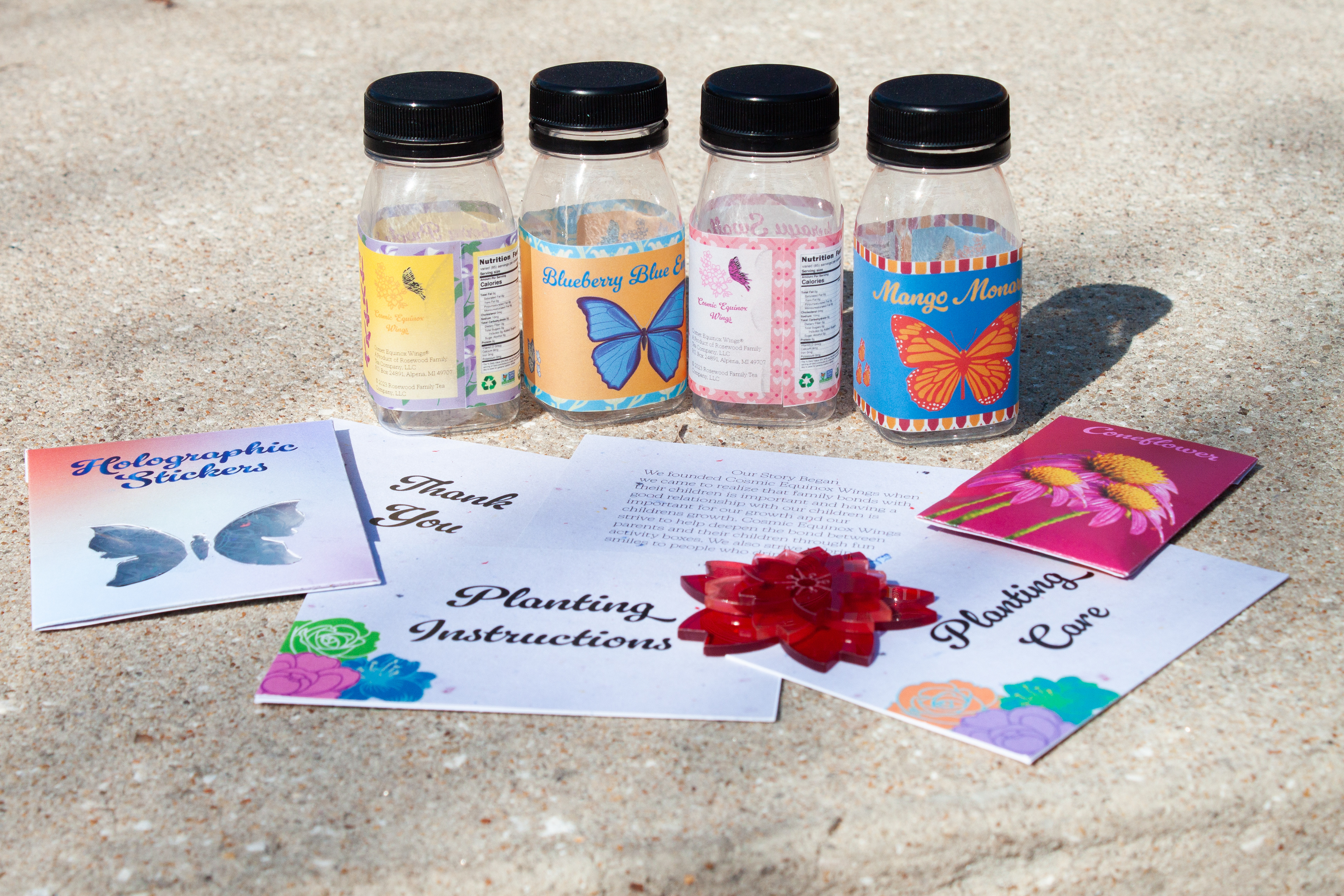 Cosmic Wings: bottles, seed packet, sticker packet, cards