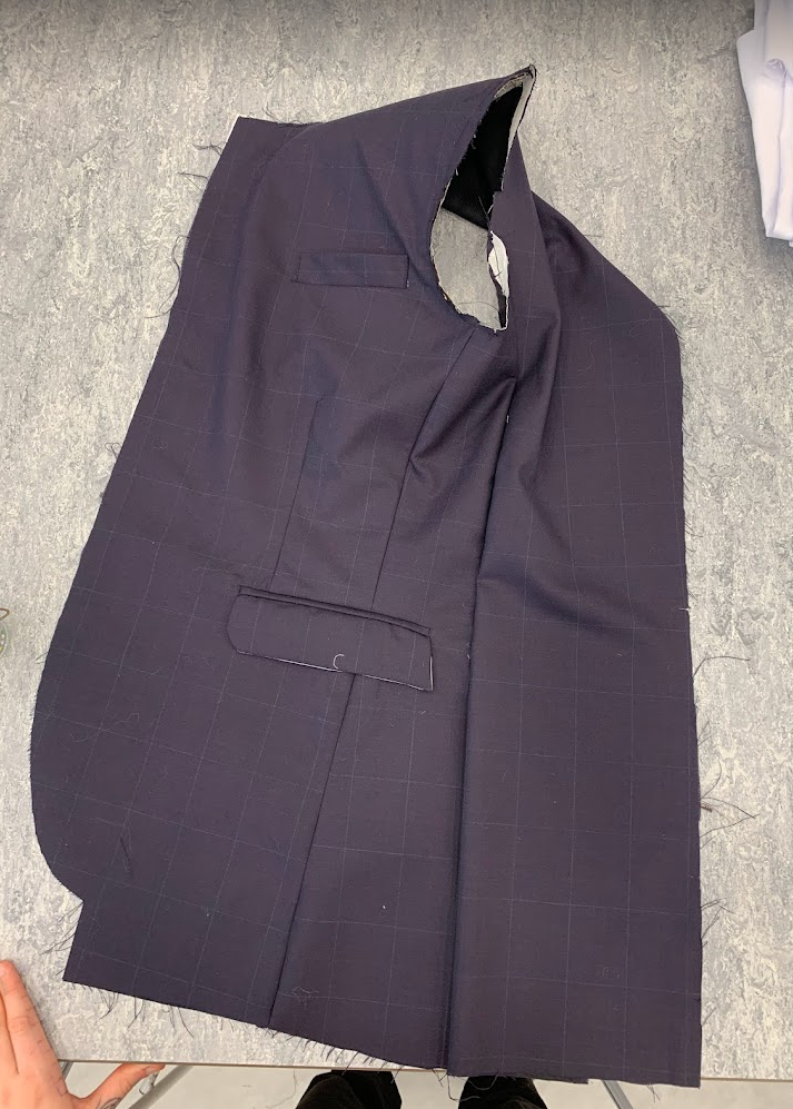 Jacket before sleeve is fitted, showing jet pocket, welt pocket, side seams and dart.