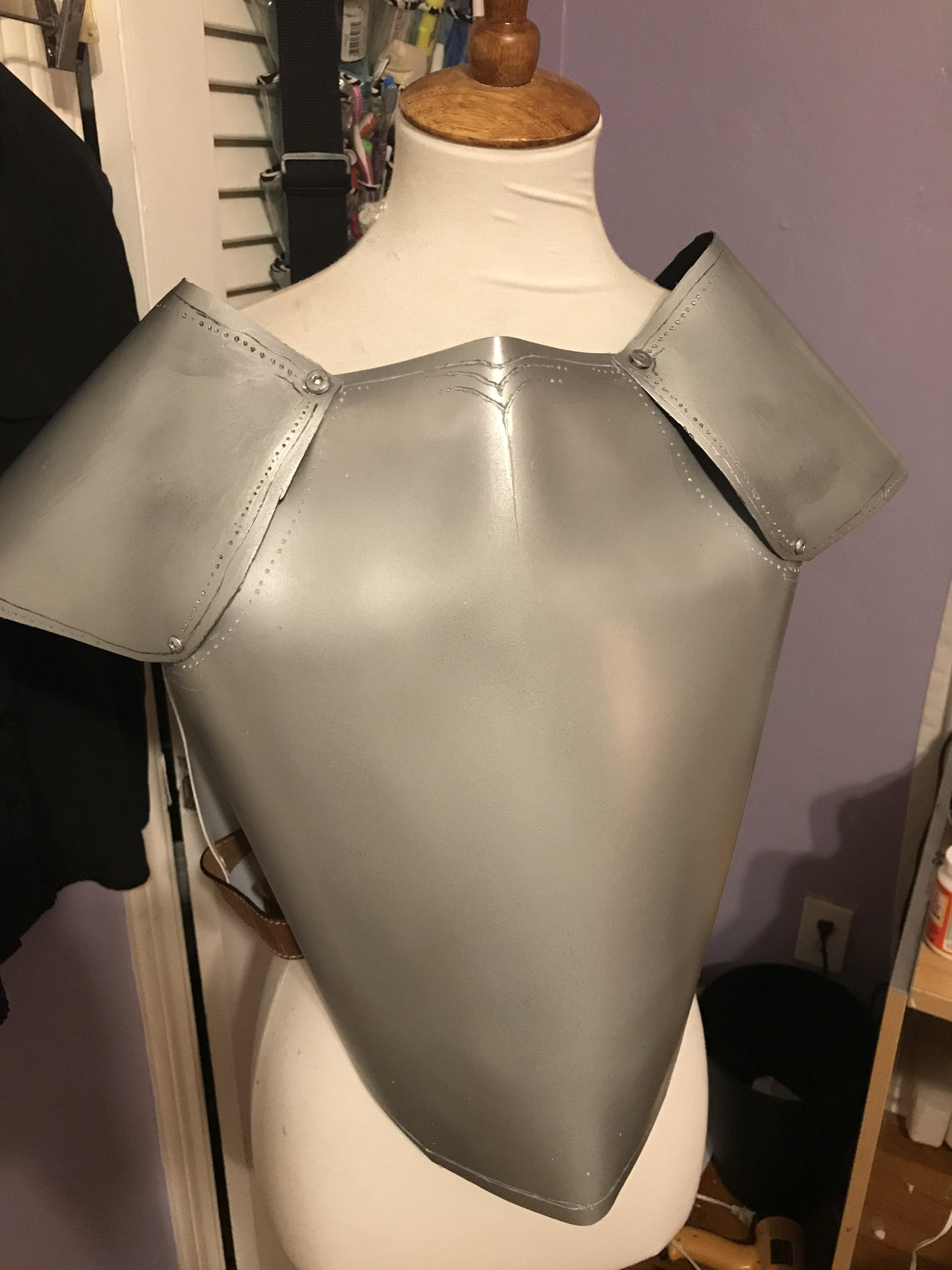 10.Once the spray paint had dried, I drilled holes into breastplate, shoulder pieces and back plate in order to fasten them together.