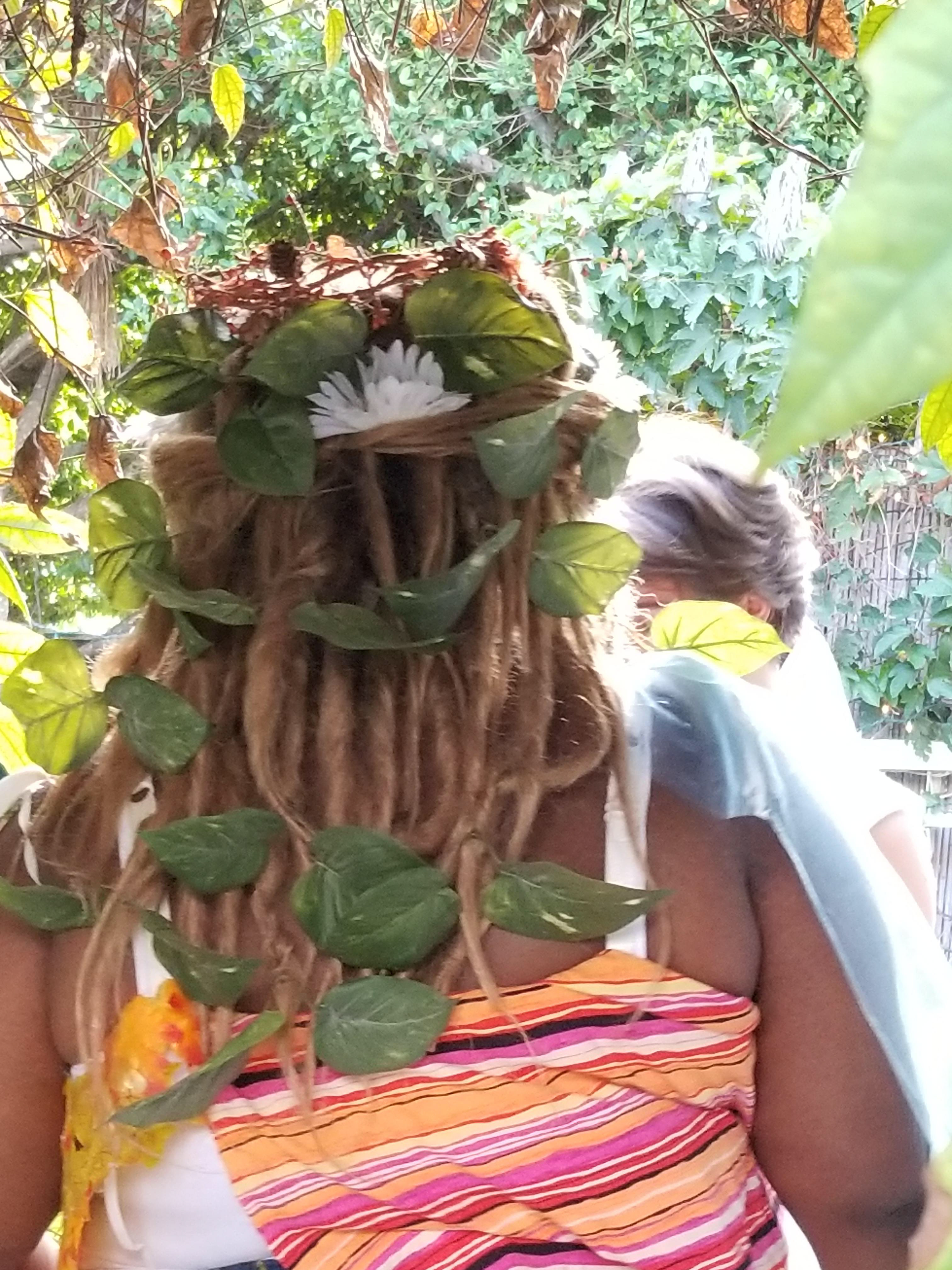 3. In the wig, I added faux flowers and leaves as if plants were growing straight out of the costume. I pinned the sheer fabric of the shoulder drape to the straps of the striped top.