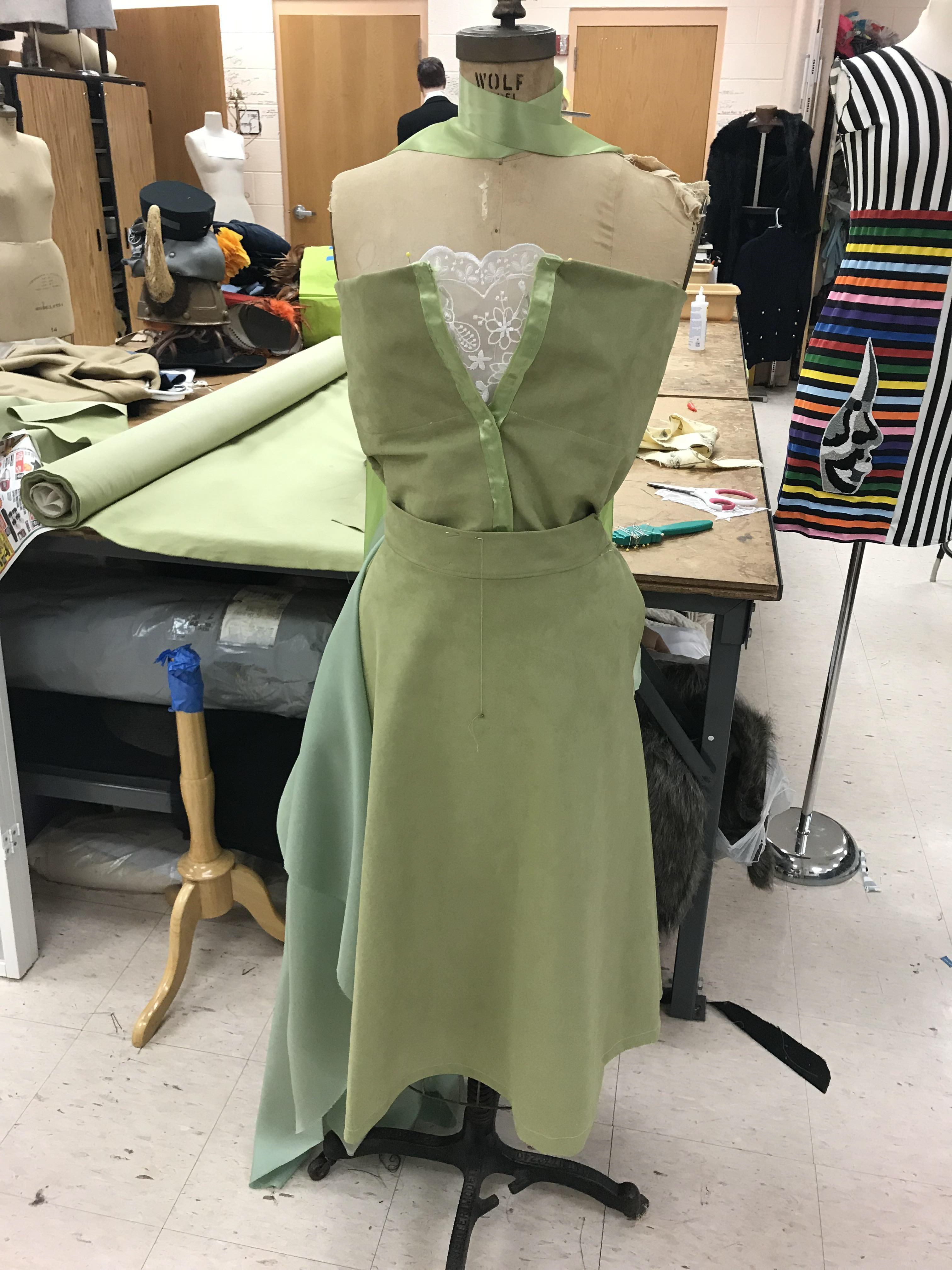 2. After sewing the clasps behind the edges of the hemmed fabric to fasten the bodice, I began working on the skirt. I first measured the waistbinding so I could cut the curve of the skirt's wasit to the proper length. When I had cut the shape of the skirt, I hemmed the unfinished edge and pinned the skirt's waist to the binding. I sewed the inner lining of the waist binding and the skirt and added clasps to the side of the skirt. (The lace front of the bodice was removed as I changed the design.))