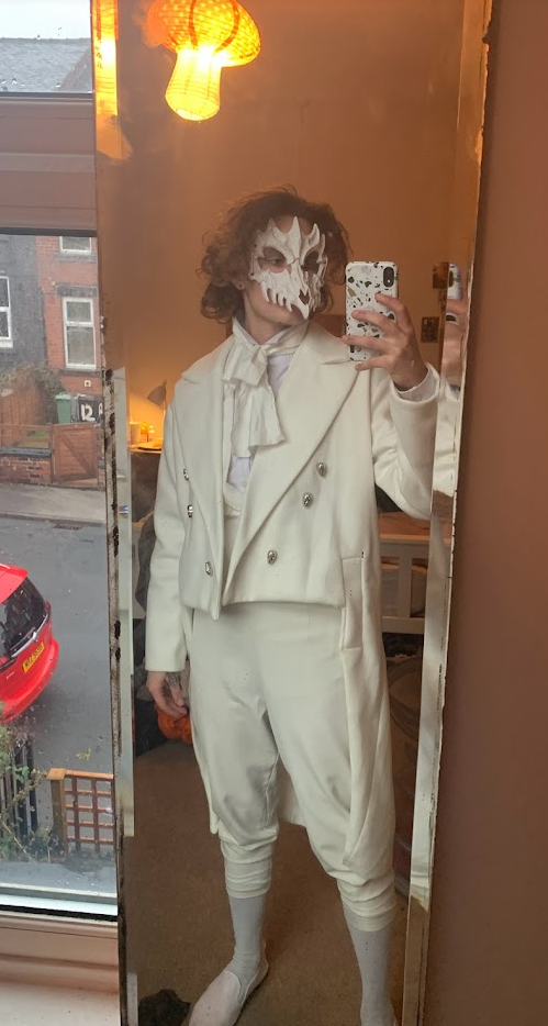 Ensemble included a necktie, dress shirt, waistcoat, cutback jacket, breeches, and a skeletal mask