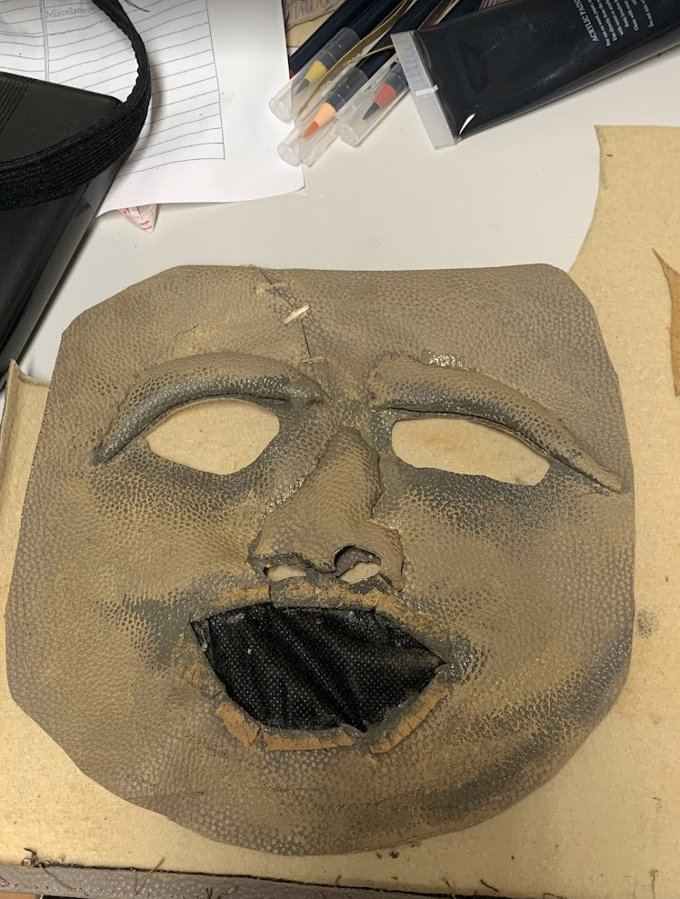 I personally made this mask from a faux leather handbag, adapting it through handstitching and painting