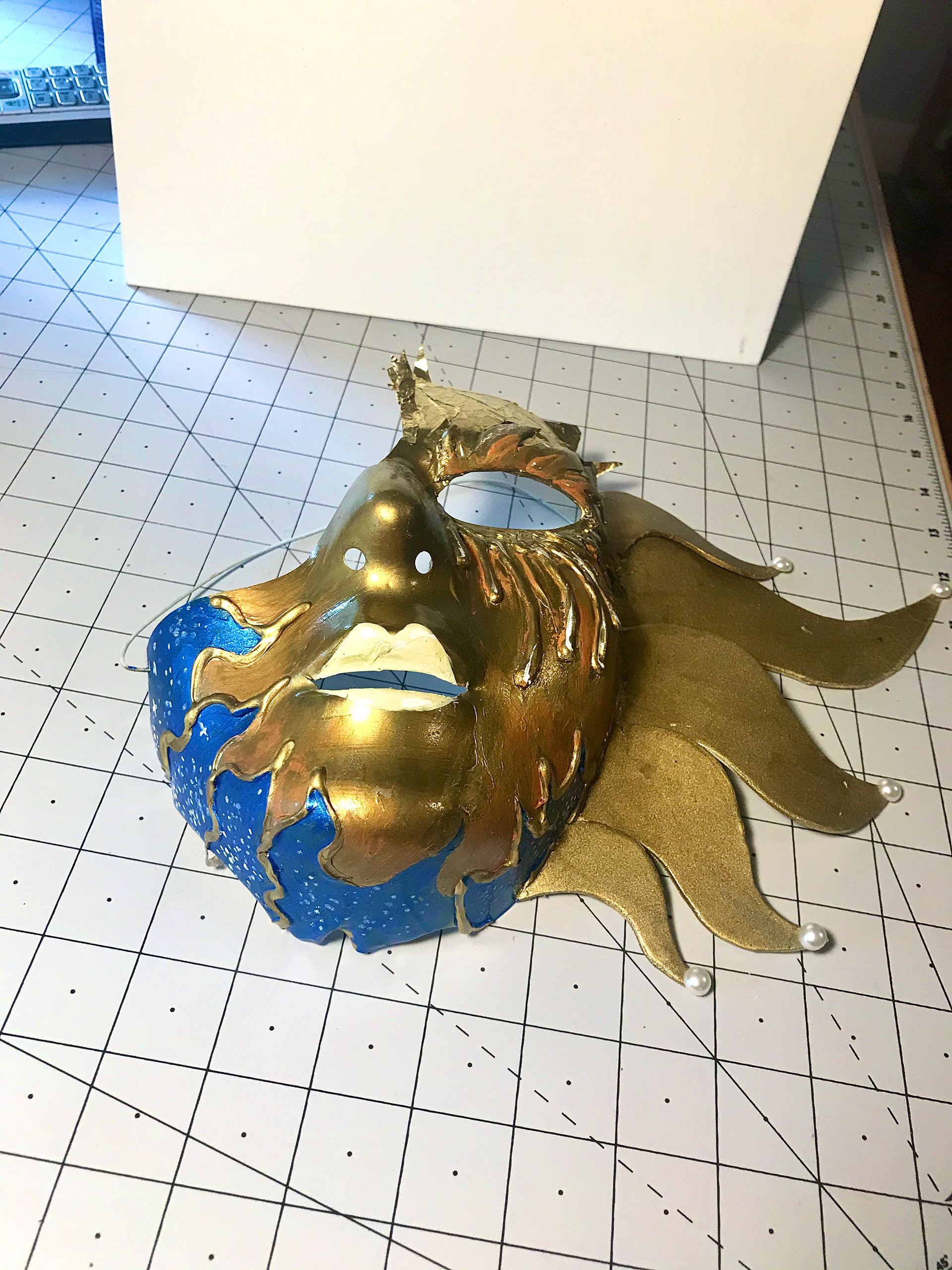 4. In the blue areas on the sun mask I dotted white and silver stars, also adding a dry paint to the shadows of the mask's face to give it a rustic texture.