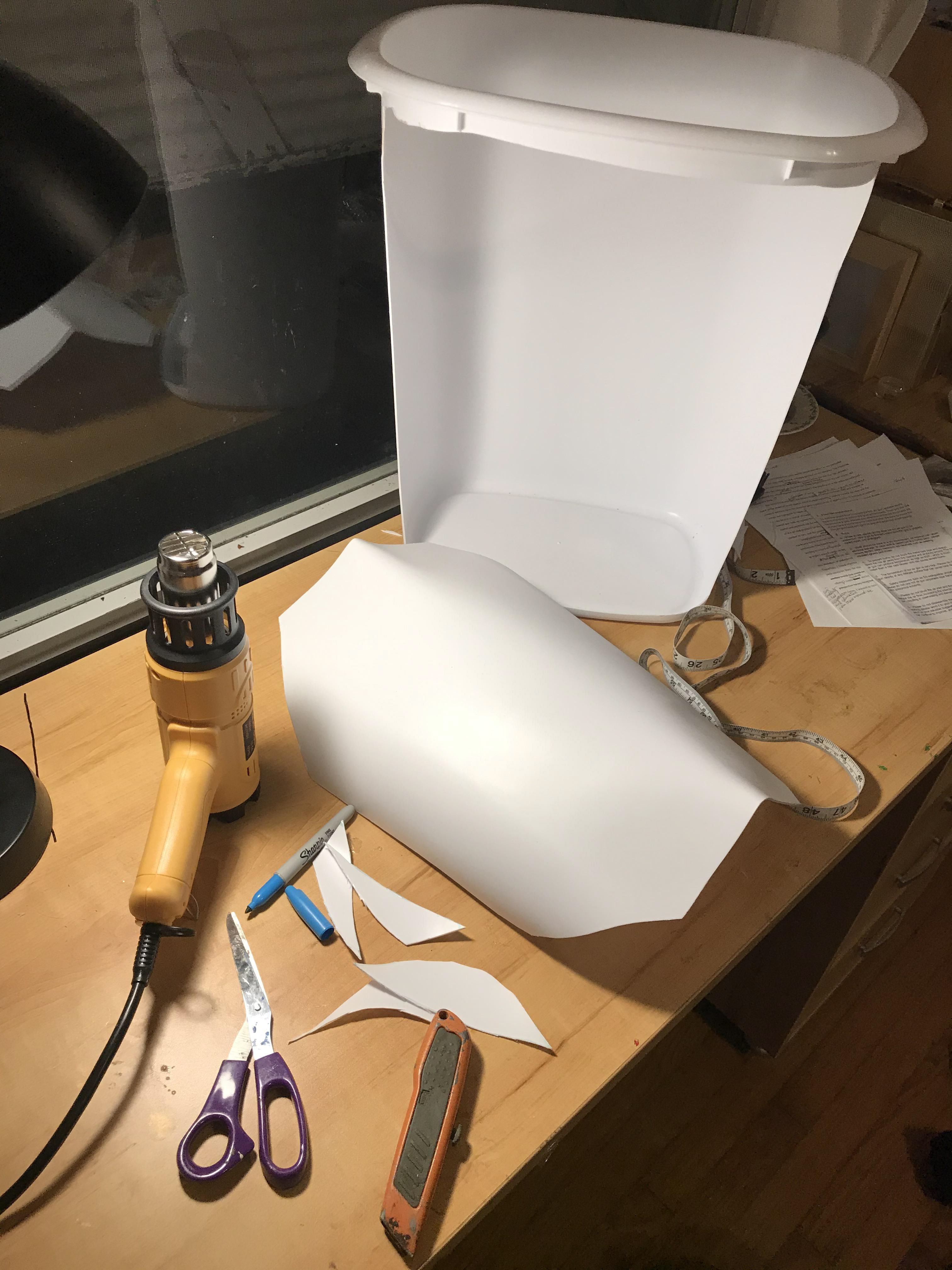 4. Using a heat gun, I softened the plastic of a trashcan to a point that a boxcutter could cut through the plastic smoothly. After cutting out a flat sheet of plastic, I heat the peak of the sheet of plastic and the sides to round to the chest of a person and look like the curvature of armour.