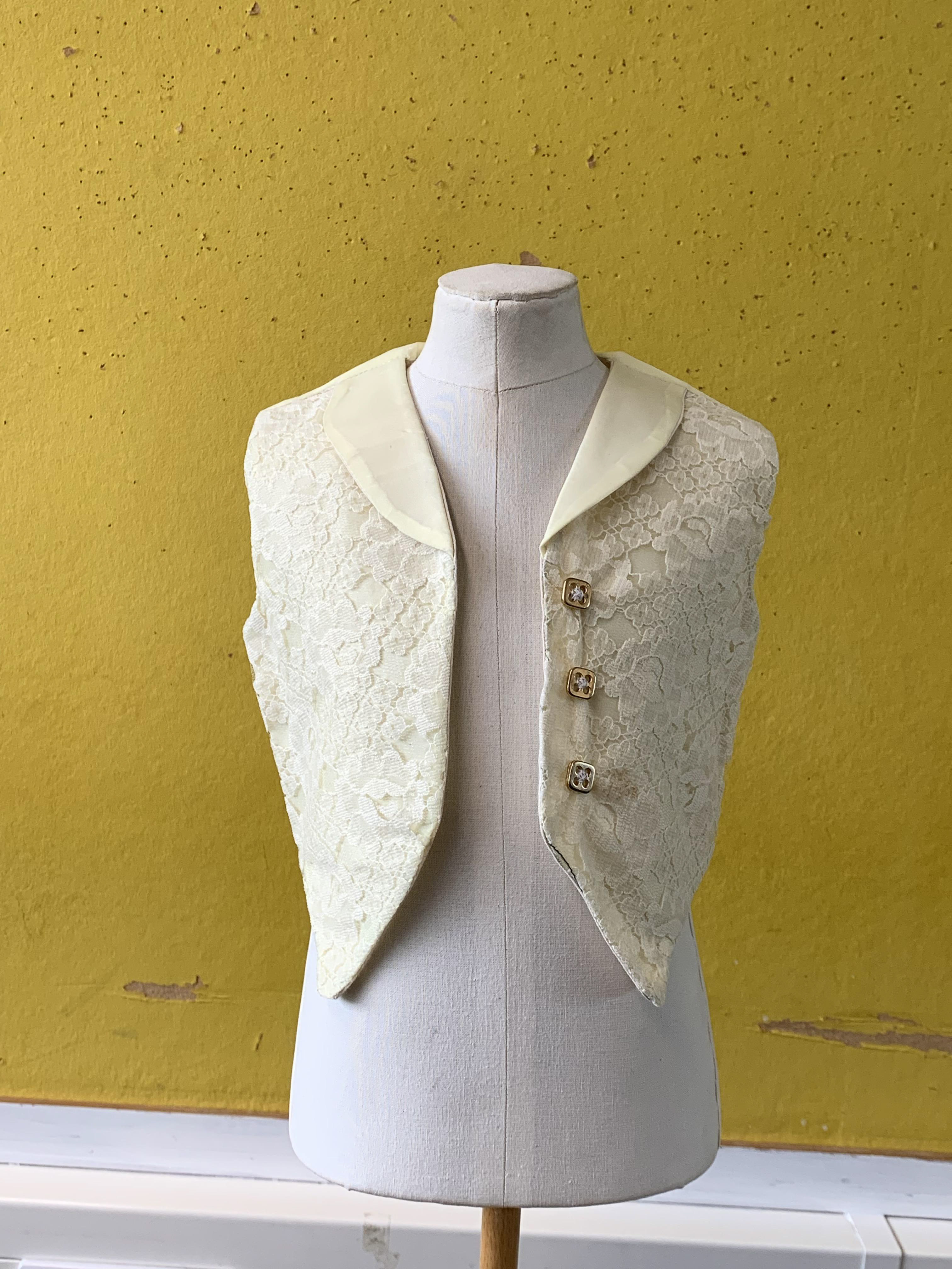 A child-size waistcoat made with yellow lining, lace and calico. Angela taught me to tricks to sewing lace and instructed me on minimal hand-sewing methods.