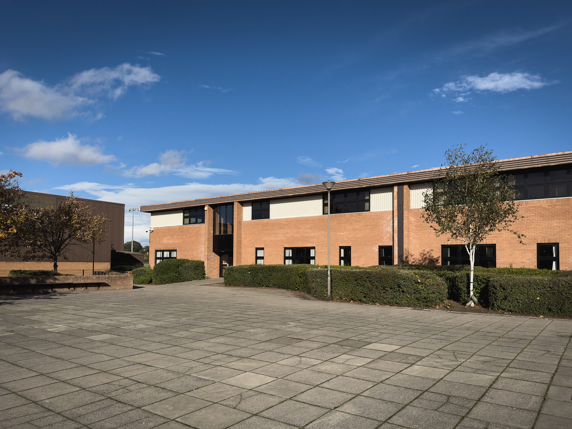 The corner of the building beside the Sports Centre.