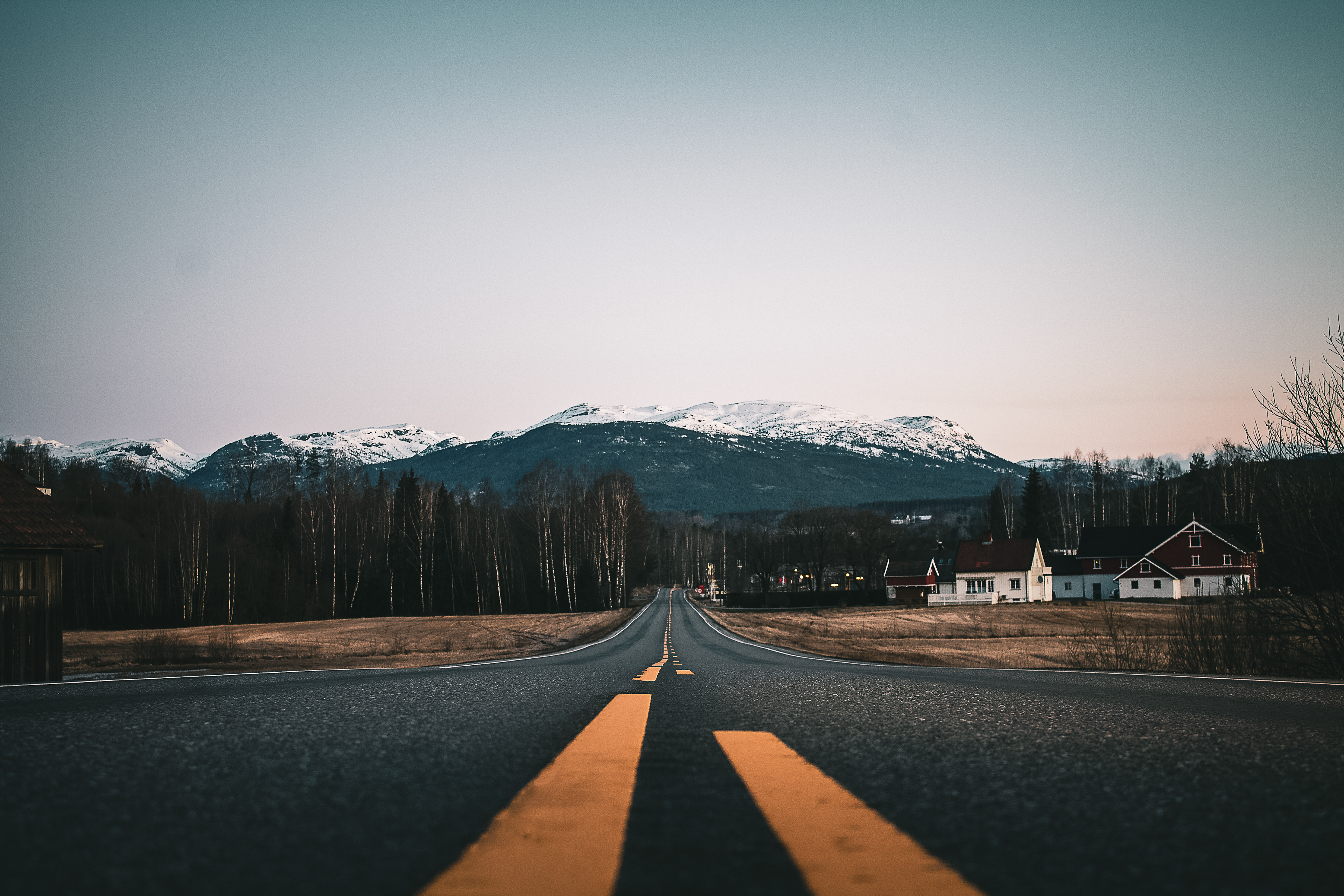 Country road with snowy mountaint peaks