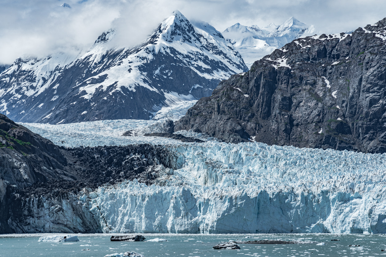 Dramatic landscape highlighted by a massive glacier located within the mountains surrounding Glacier Bay, Alaska.