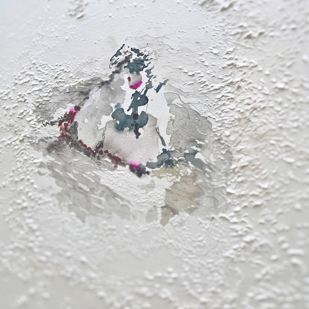 close up view of a carved paper art with its center being a water color of a rock formation in the middle of the sea- it is a modern interpretation of a seaside painting- carved paper around the water color painting are rhythmic and capture motions that can bring to mid waves, fog and space. The rock is painted in brushstrokes and soft washes in soft teals, greys and moss green and accented with lively pink.