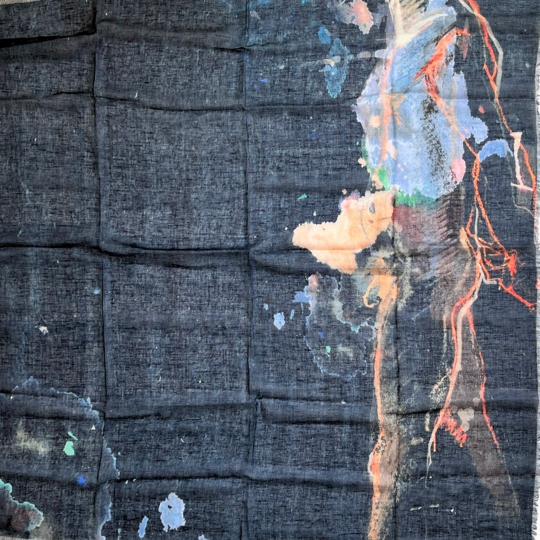 A square Indigo linen fabric showing an expressionistic figure painting on the right side, featuring vibrant shades of purple, orange, soft brown, dusty amber, and grays.