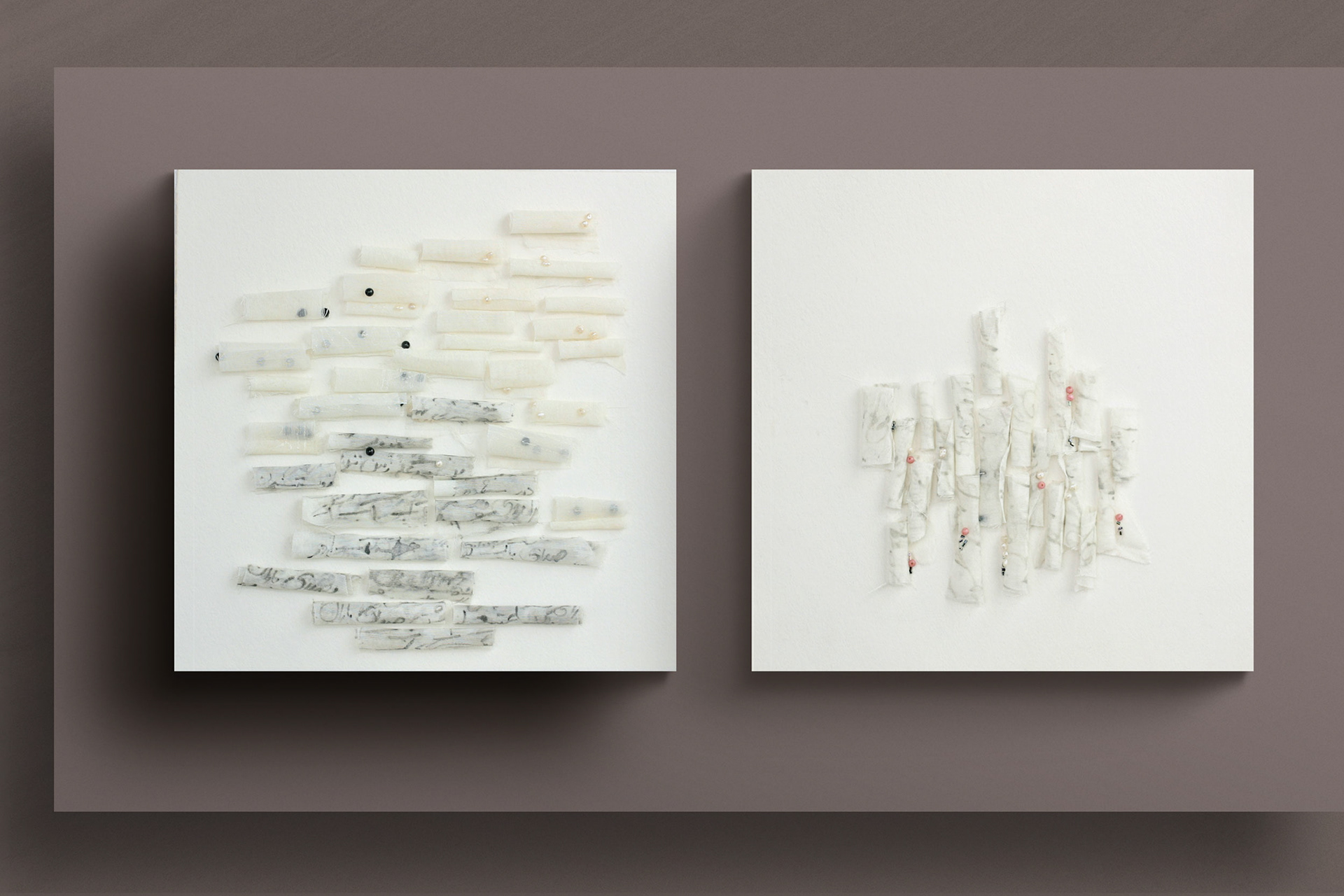 full view of 37 Poem Scrolls next to 20 Poem Scrolls art on mauve gallery wall