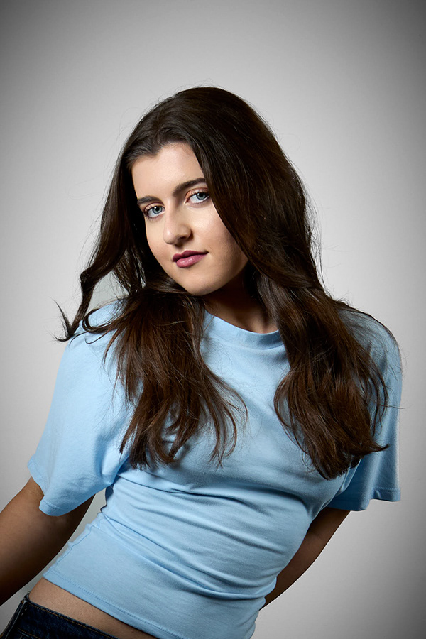 Studio-style portrait of a woman against a soft background