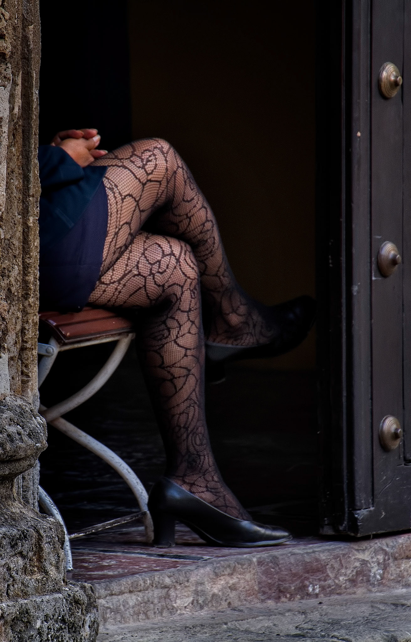 A policewoman guarding a door in Havana, Cuba.