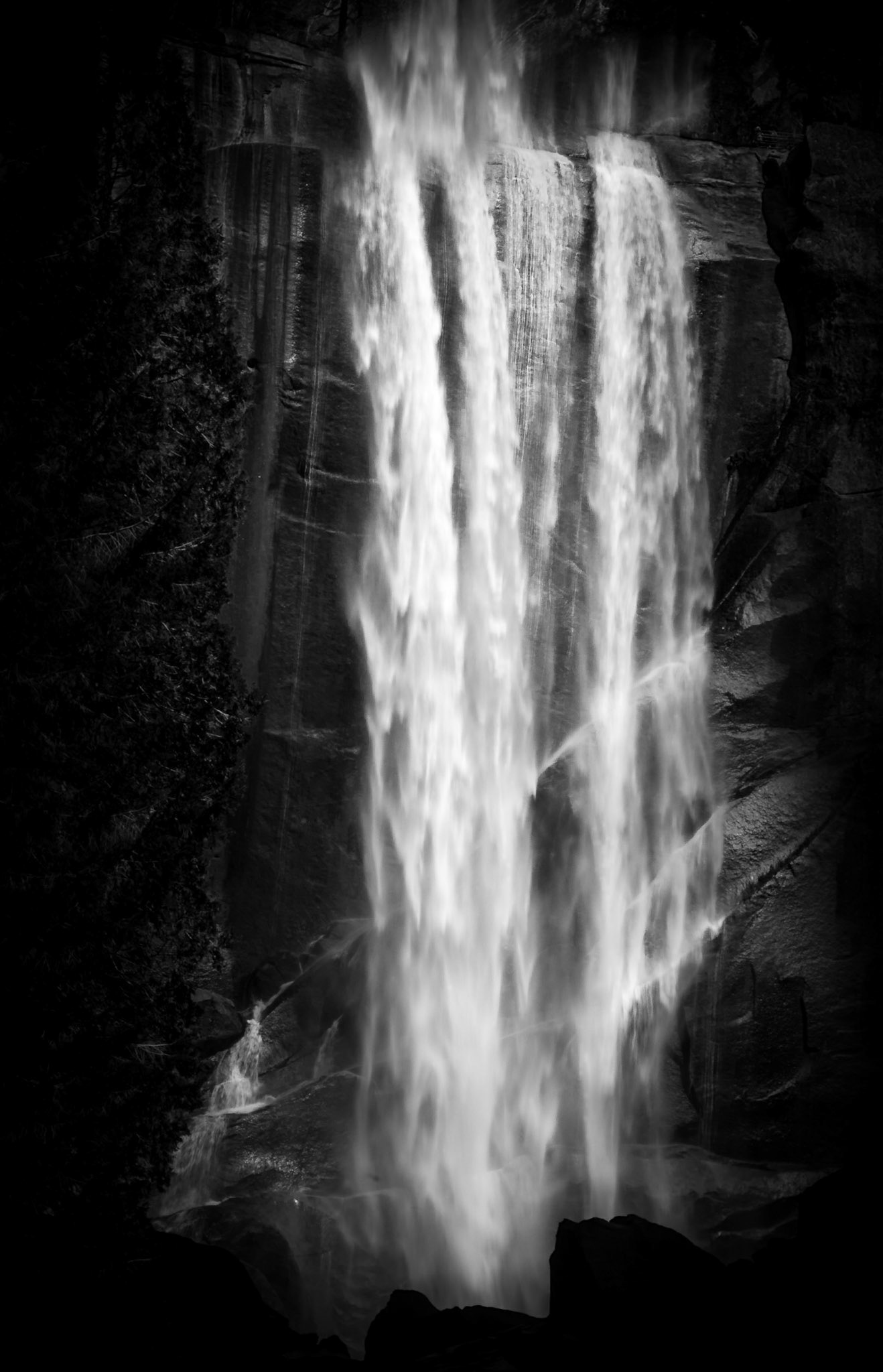 Vernal Fall is a 317-foot (96.6 m) waterfall on the Merced River just downstream of Nevada Fall in Yosemite National Park, California. Vernal Fall, as well as Nevada Fall, is clearly visible from Glacier Point. The waterfall runs all year long, although by the end of summer it is substantially reduced in volume and can split into multiple strands, rather than a single curtain of water. Even though this shot was taken in spring, the effect of the Californai drought and low rainfall over the last winter is evident.