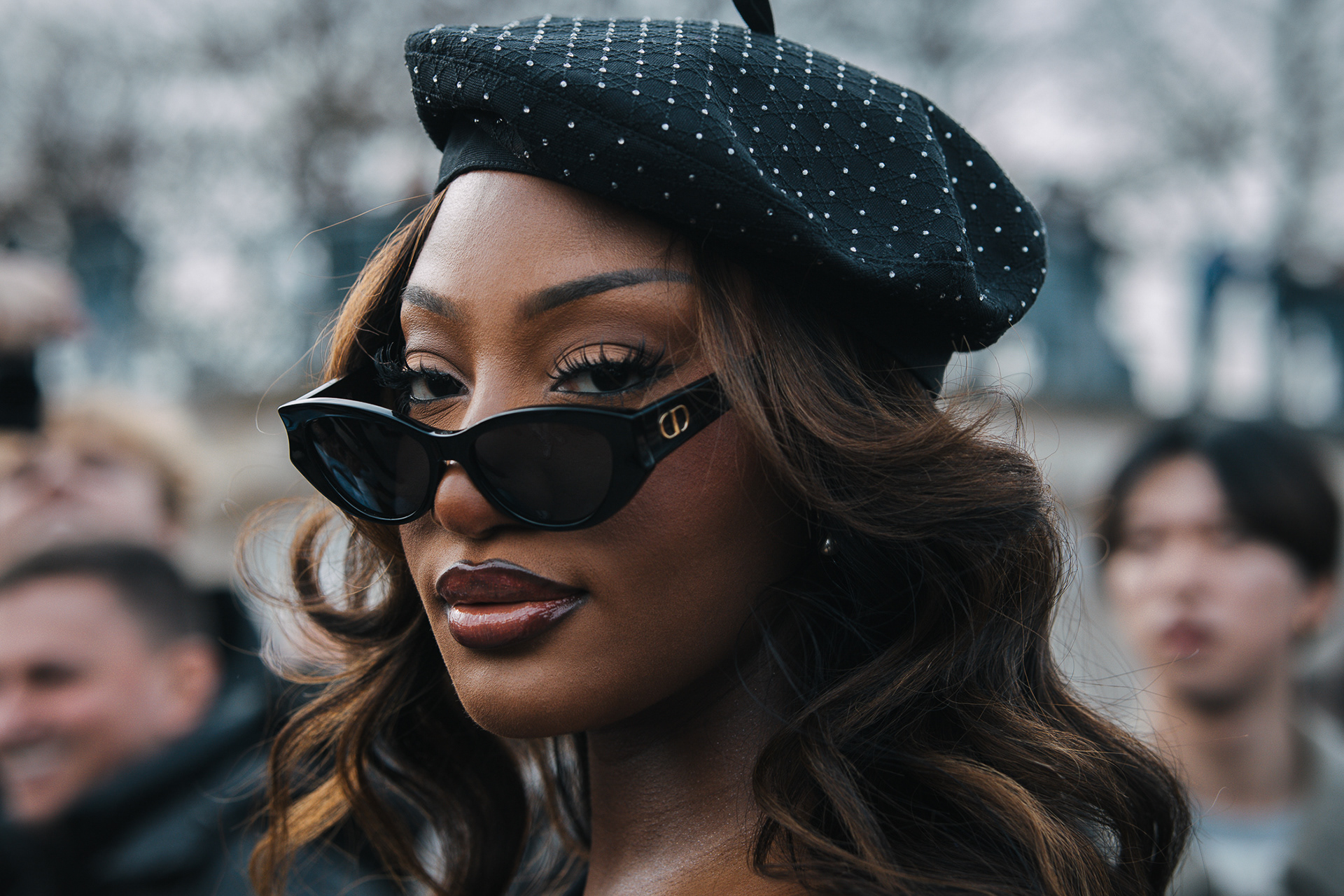 Singer Tems wearing Christian Dior Sunglasses and looking at the camera on her way to Dior show during Paris Fashion Week