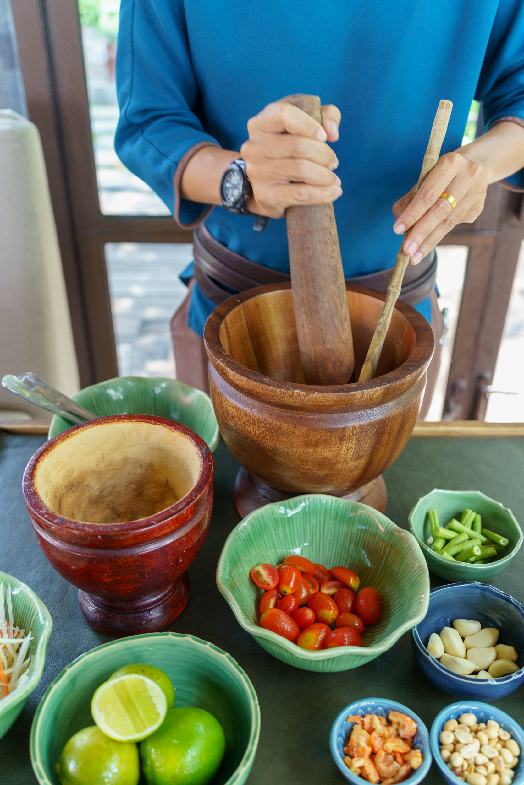 Chef at Ta Khai Restaurant Phuket Preparing Food (Som Tam)