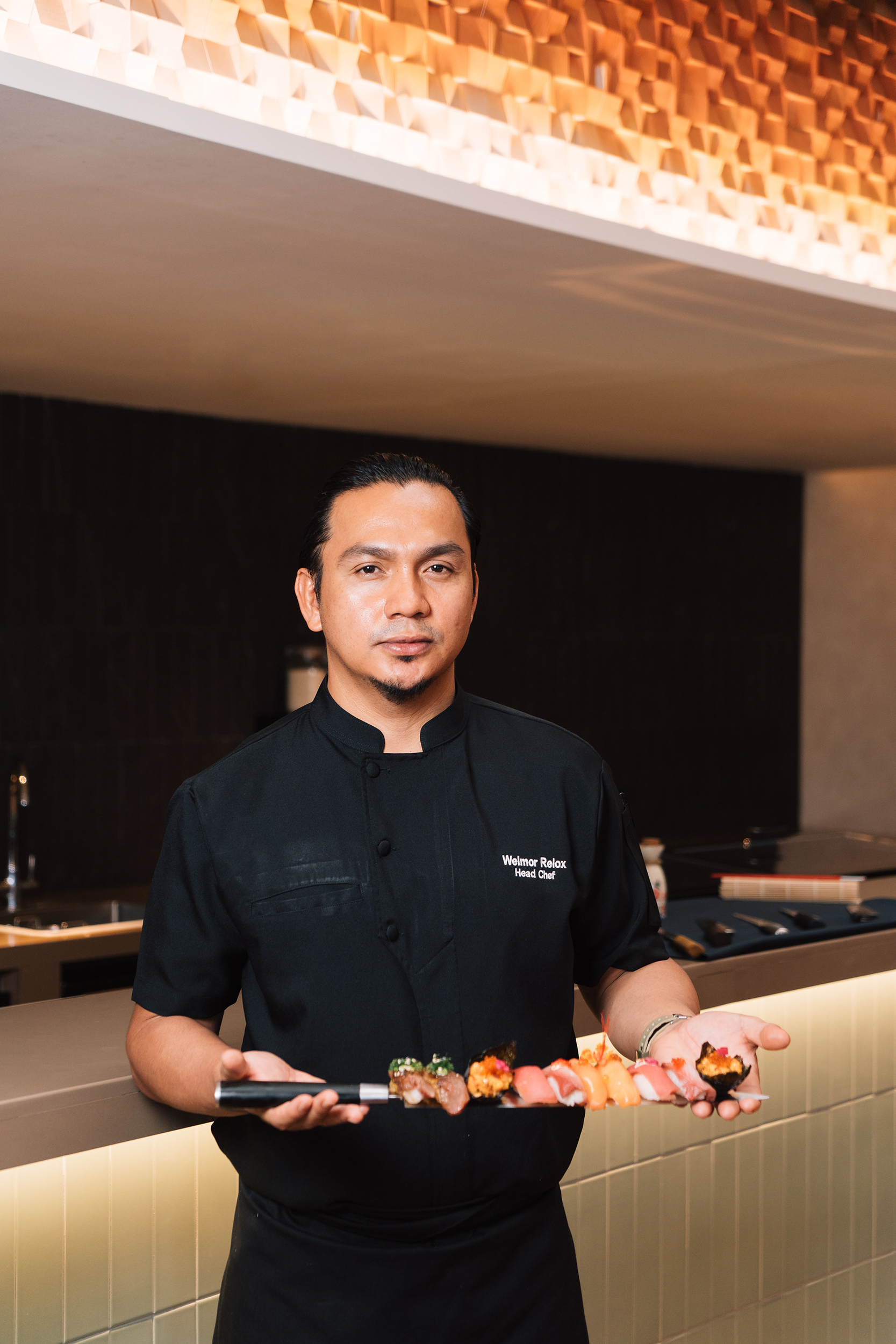 Japanese food chef with sushi menu on knife