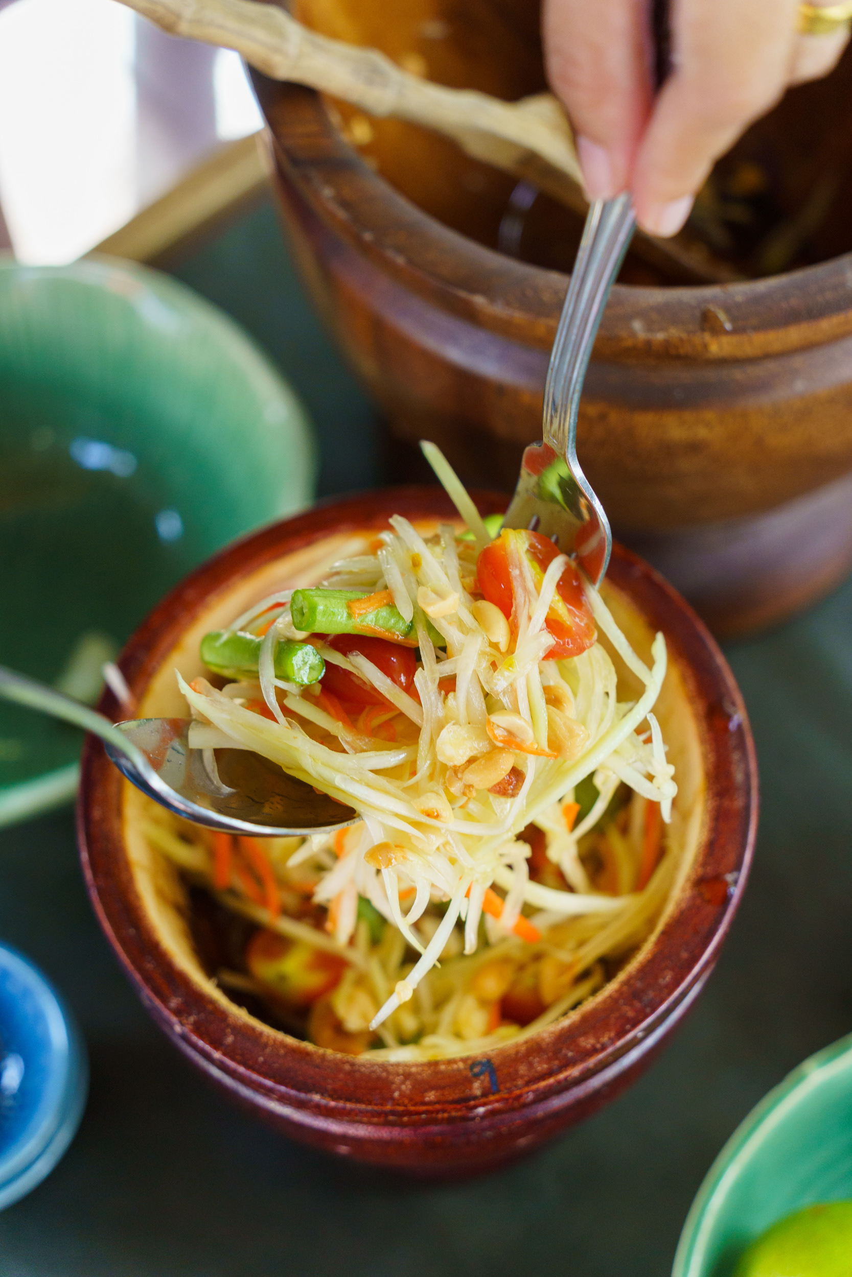 Chef at Ta Khai Restaurant Phuket Preparing Food (Som Tam)