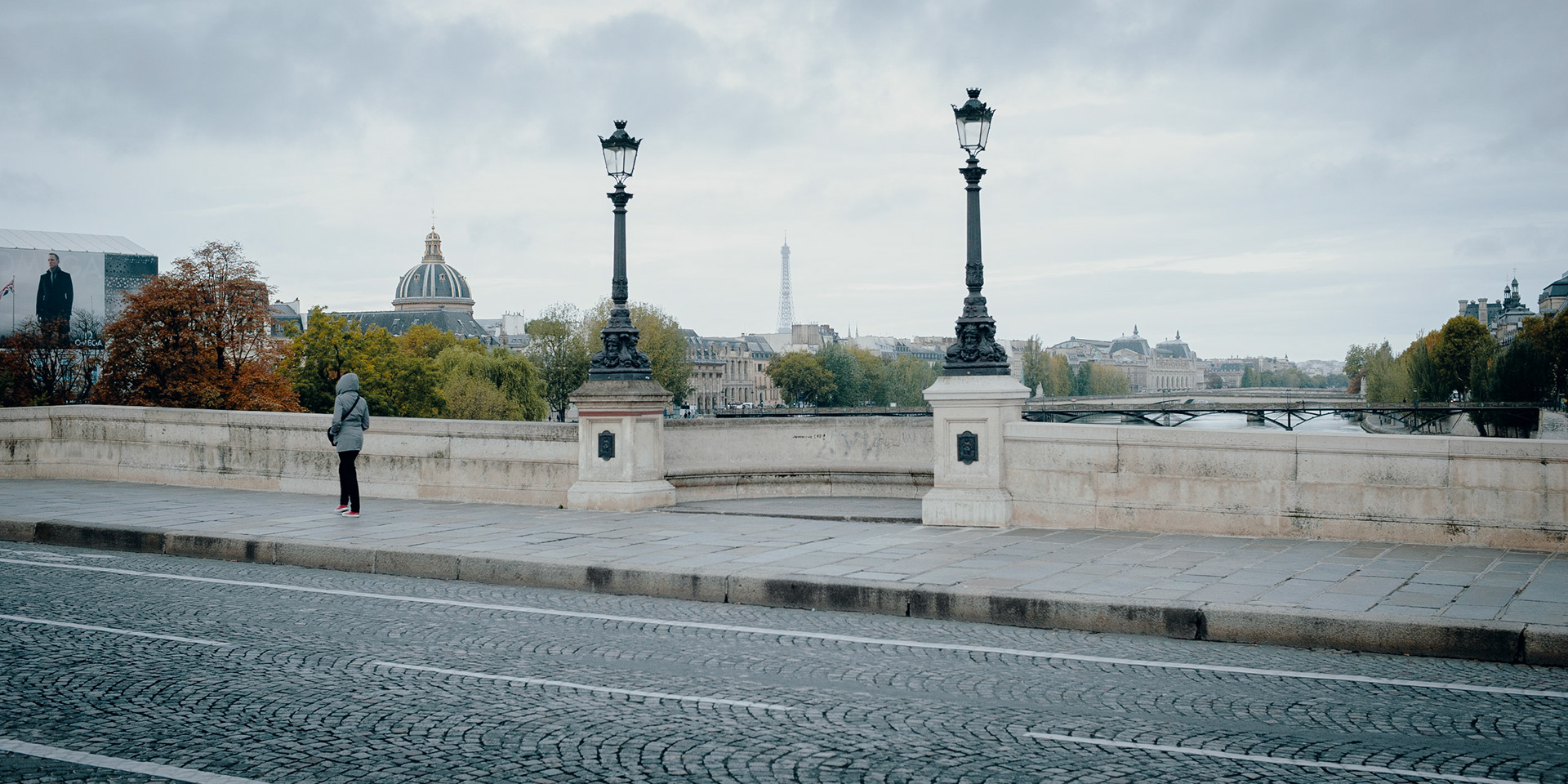 This picture’s got it all: the Seine, the Pont-Neuf, the Pont des Arts, the Orsay, the Louvre, the Institute of France, the Eiffel Tower, a Parisienne, and, yes, James Bond.