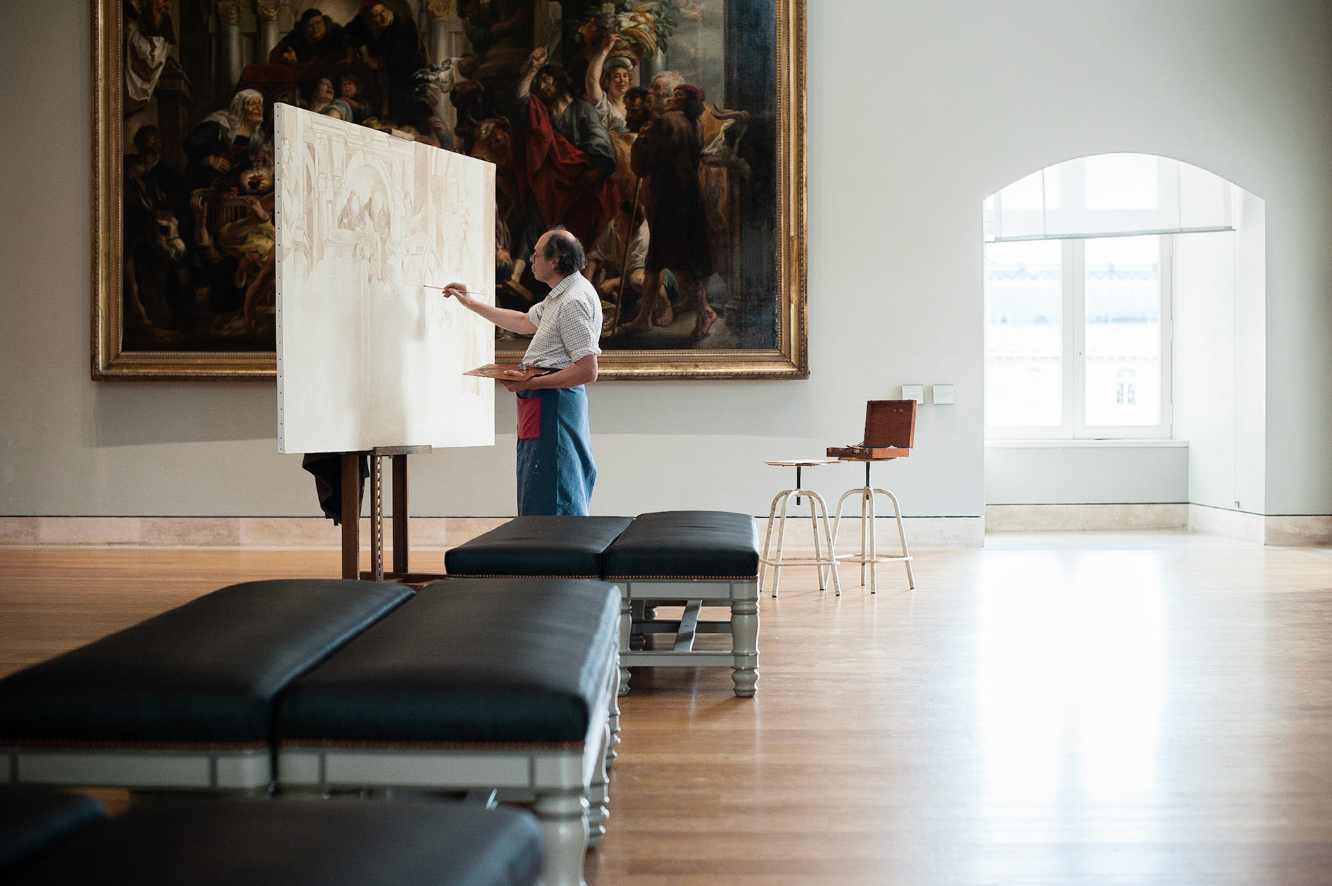 An artist painting in the Louvre