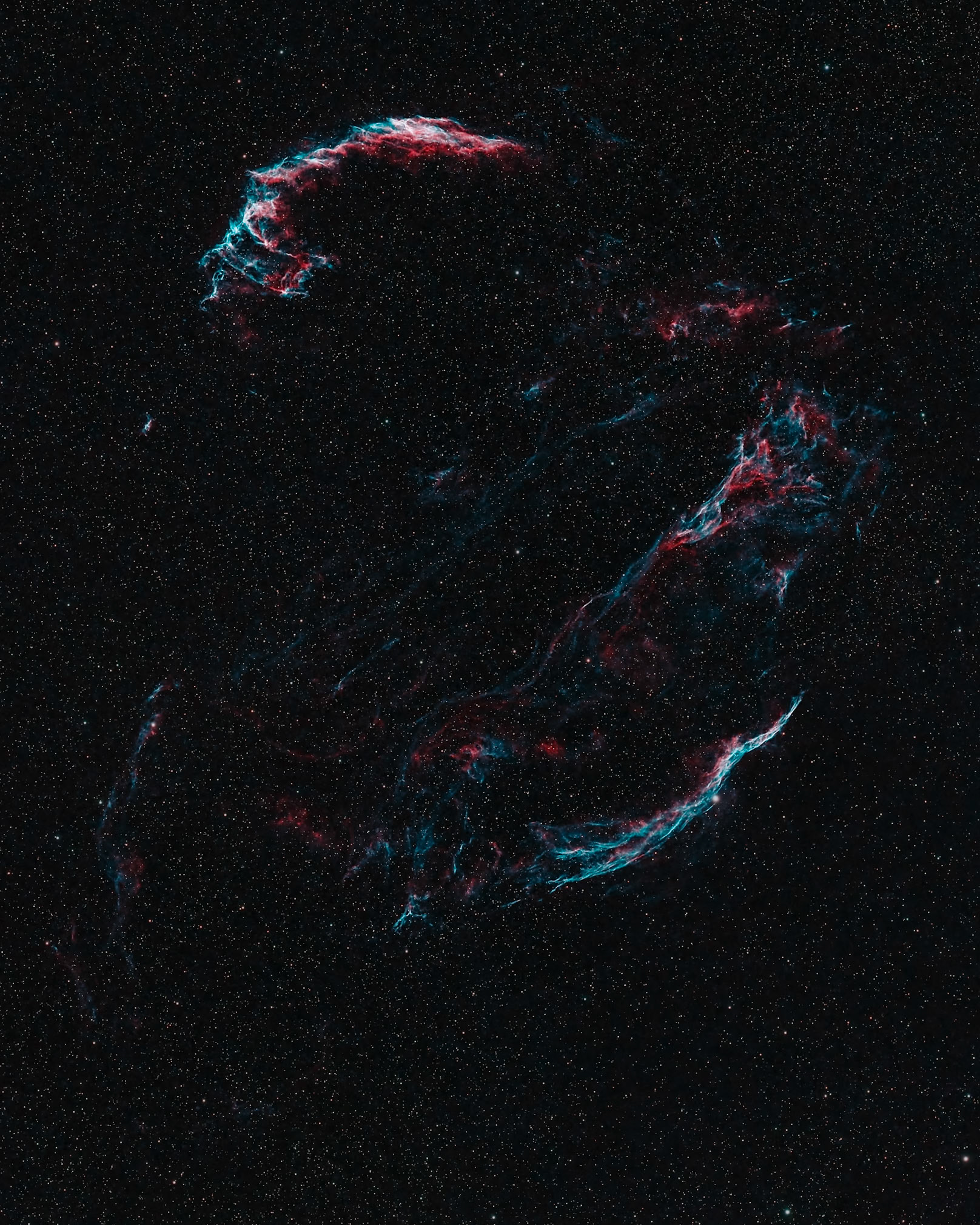 The Cygnus Loop, a supernova remnant, comprising of the two halves of the VeilNebula, as well as several other objects includingPickering's Triangle and. The Western Veil (NGC 6960), in the lower right of this image, is also known as the "Witch's Broom" and you can clearly see why!