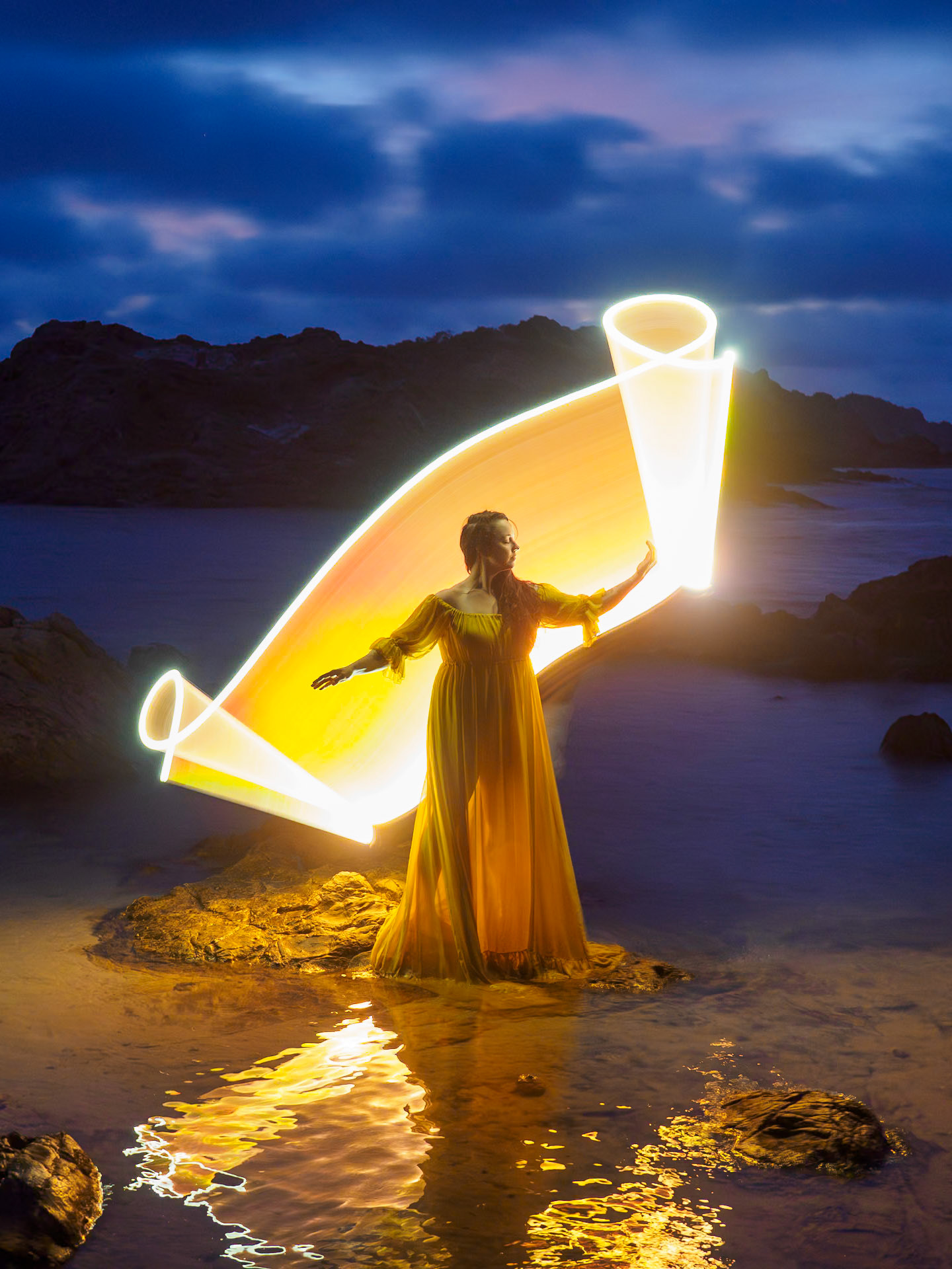 Shot during a light painting workshop with Eric Paré in Menorca, with Sarah Lyndsay as the model while Eric created the light trails using light tubes, during blue hour at Cala Pergonda
