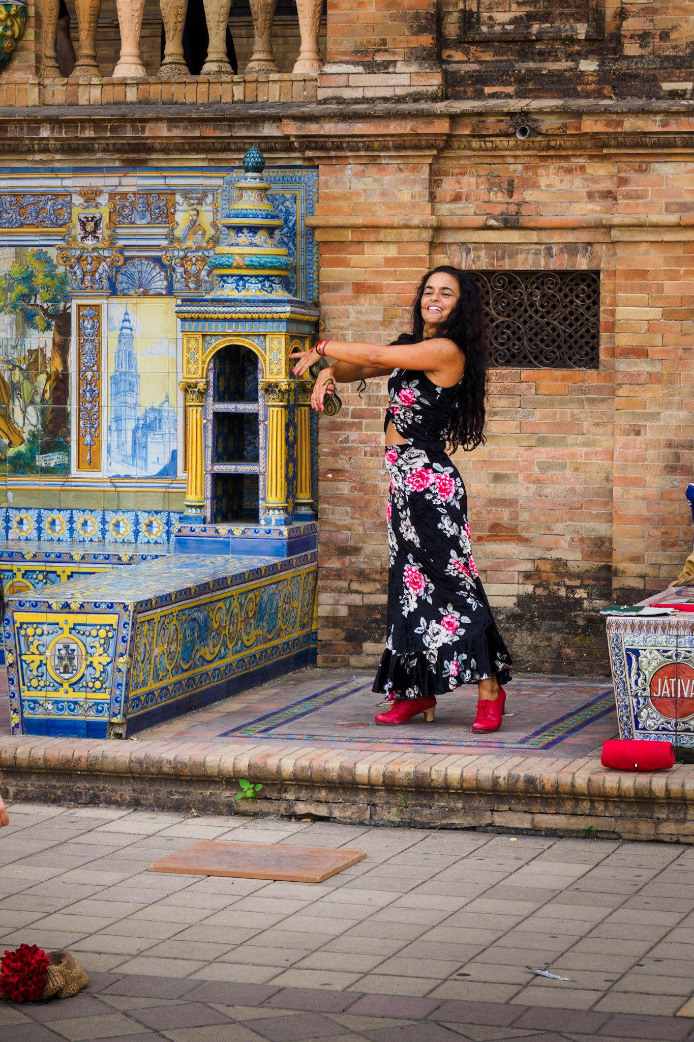 An enthusiastic flamenco dancer performs in Plaza de Espana in Seville.