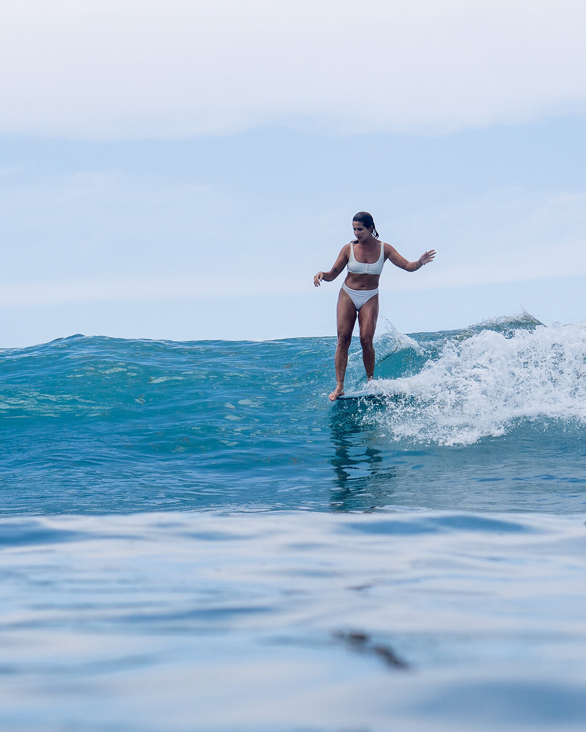 Chloe Calmon gracefully gliding on her longboard at Lombok, Indonesia