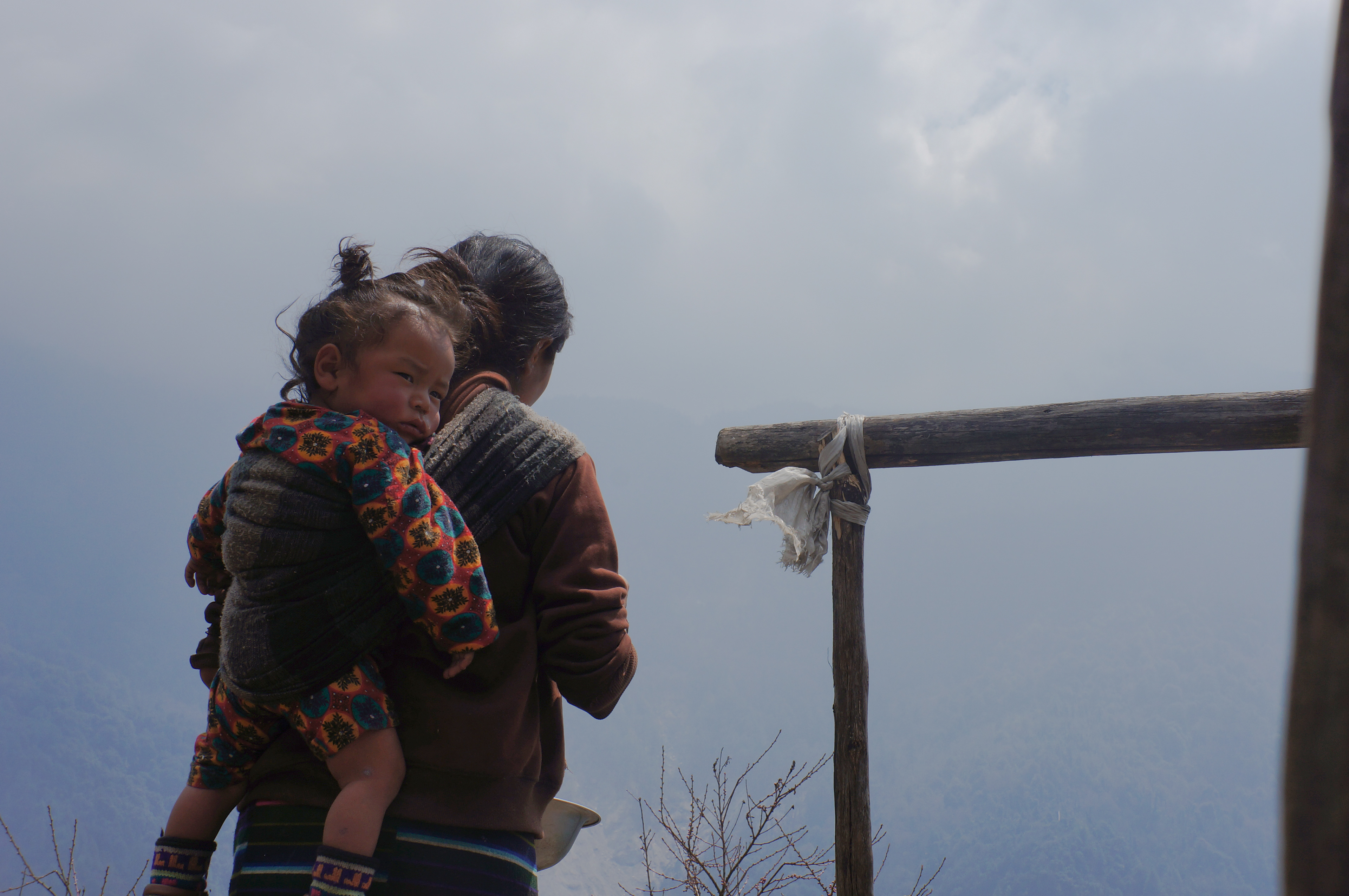 Lhakpa Tamong carries her daughter Gita