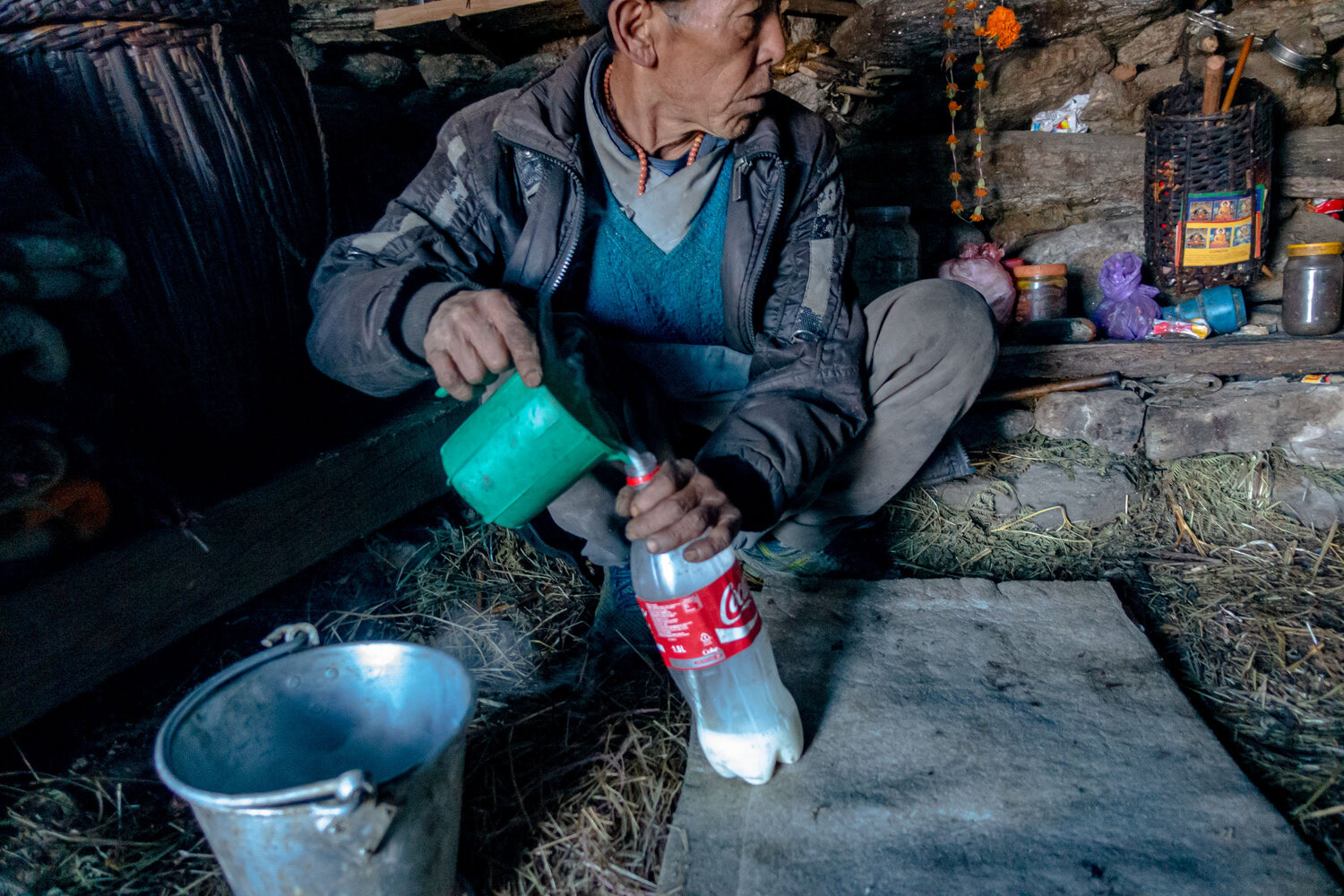 A herder prepairs fresh yak milk for Chai (tea)