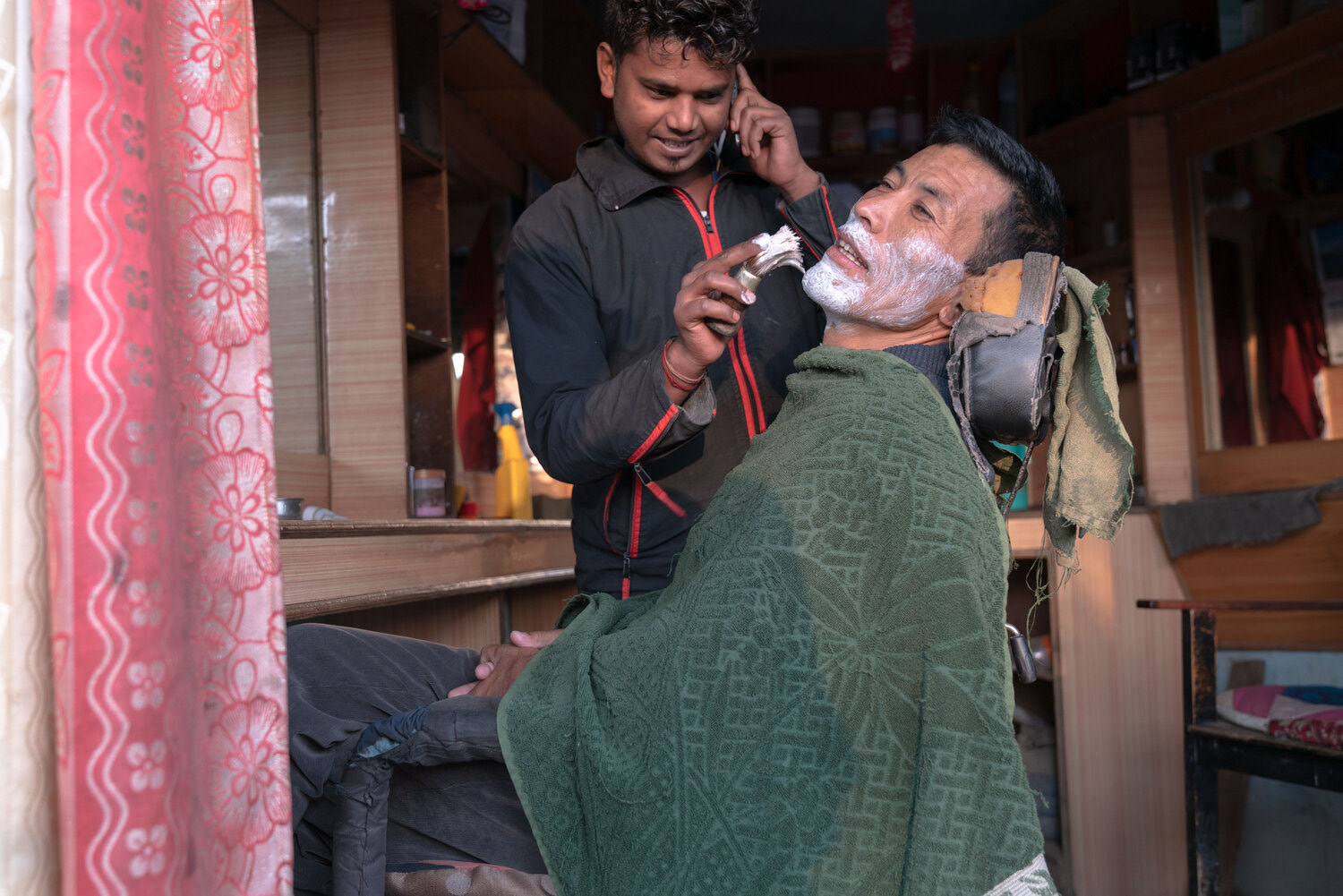 Tenjin gets a shave by the bus terminal, before leaving for Langtang