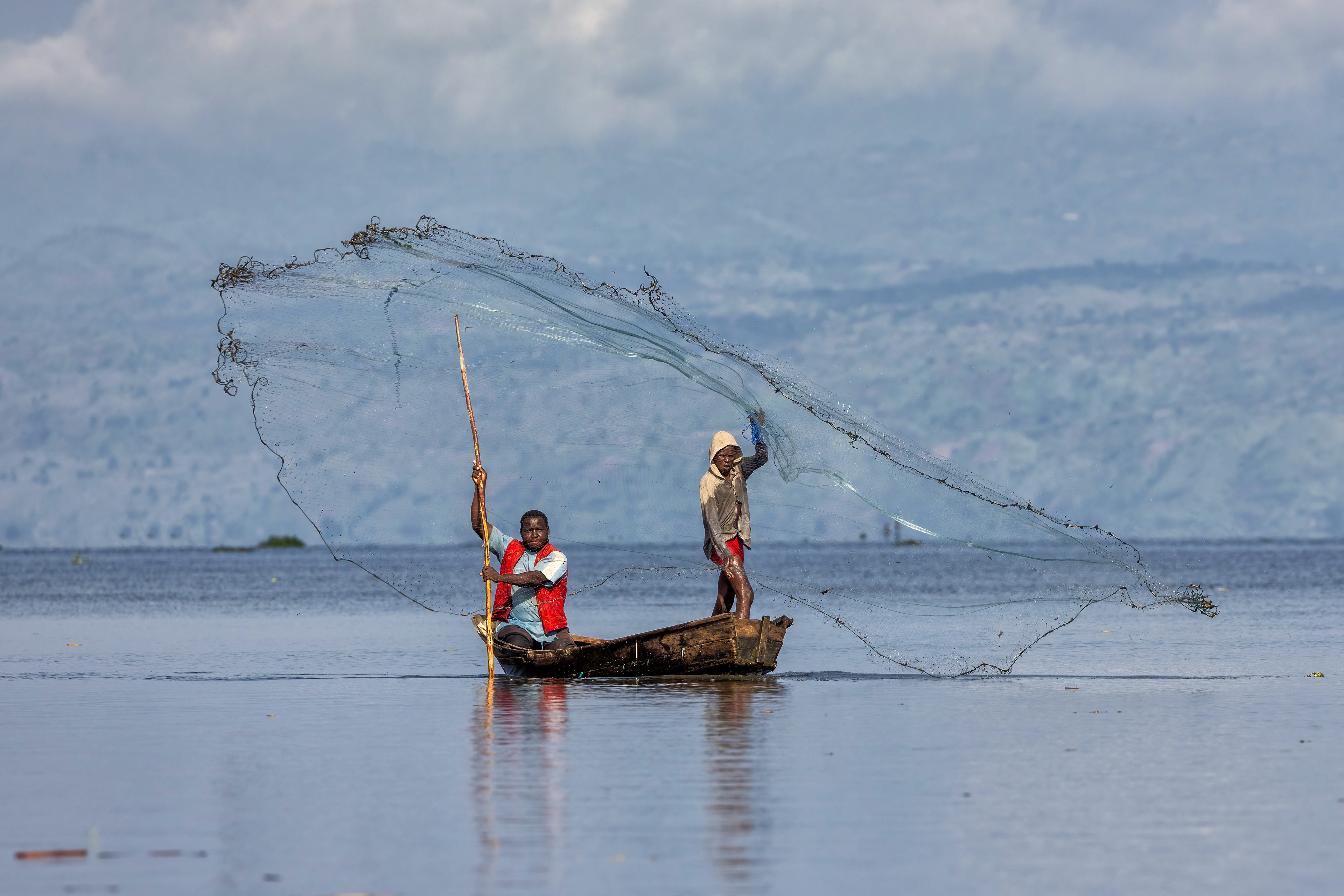Fishermen casting their net in Lake Albert, Uganda - RM