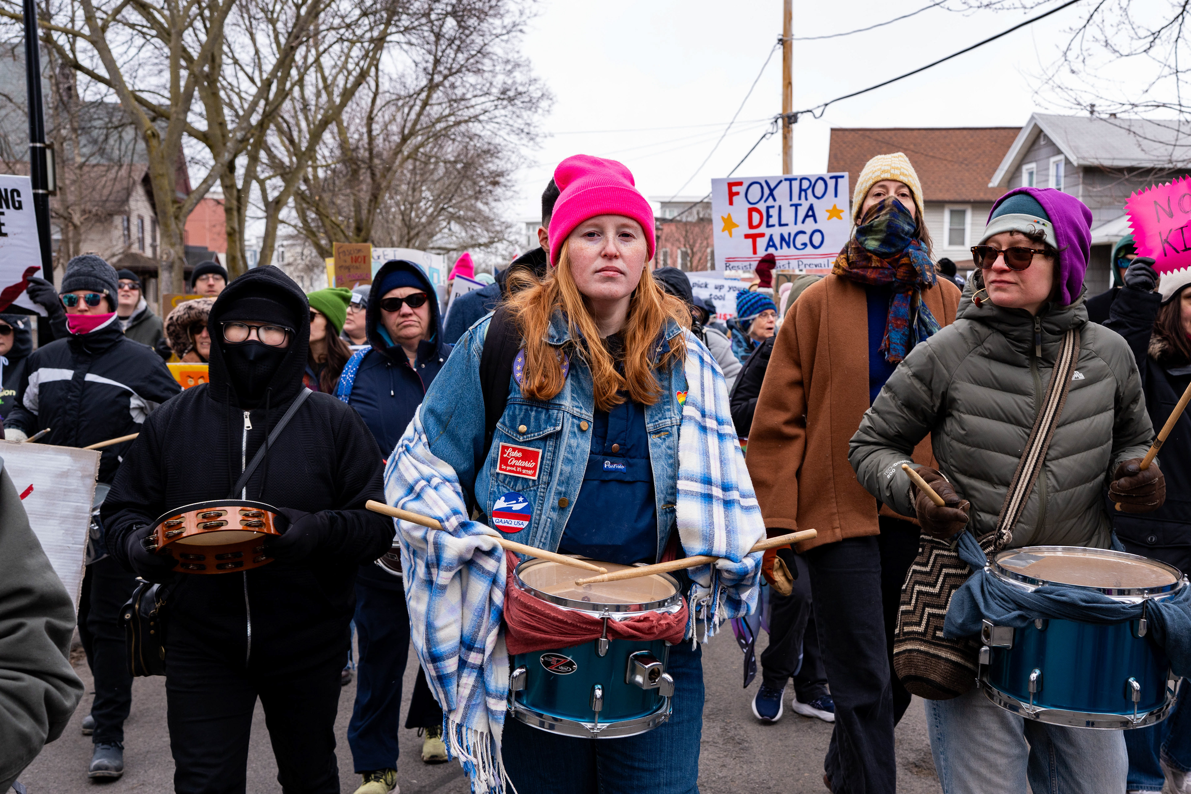 Demonstrators play drums and a tambourine during a No Kings march from Genesee Gateway Park in Rochester, N.Y., Saturday, March 28, 2026.