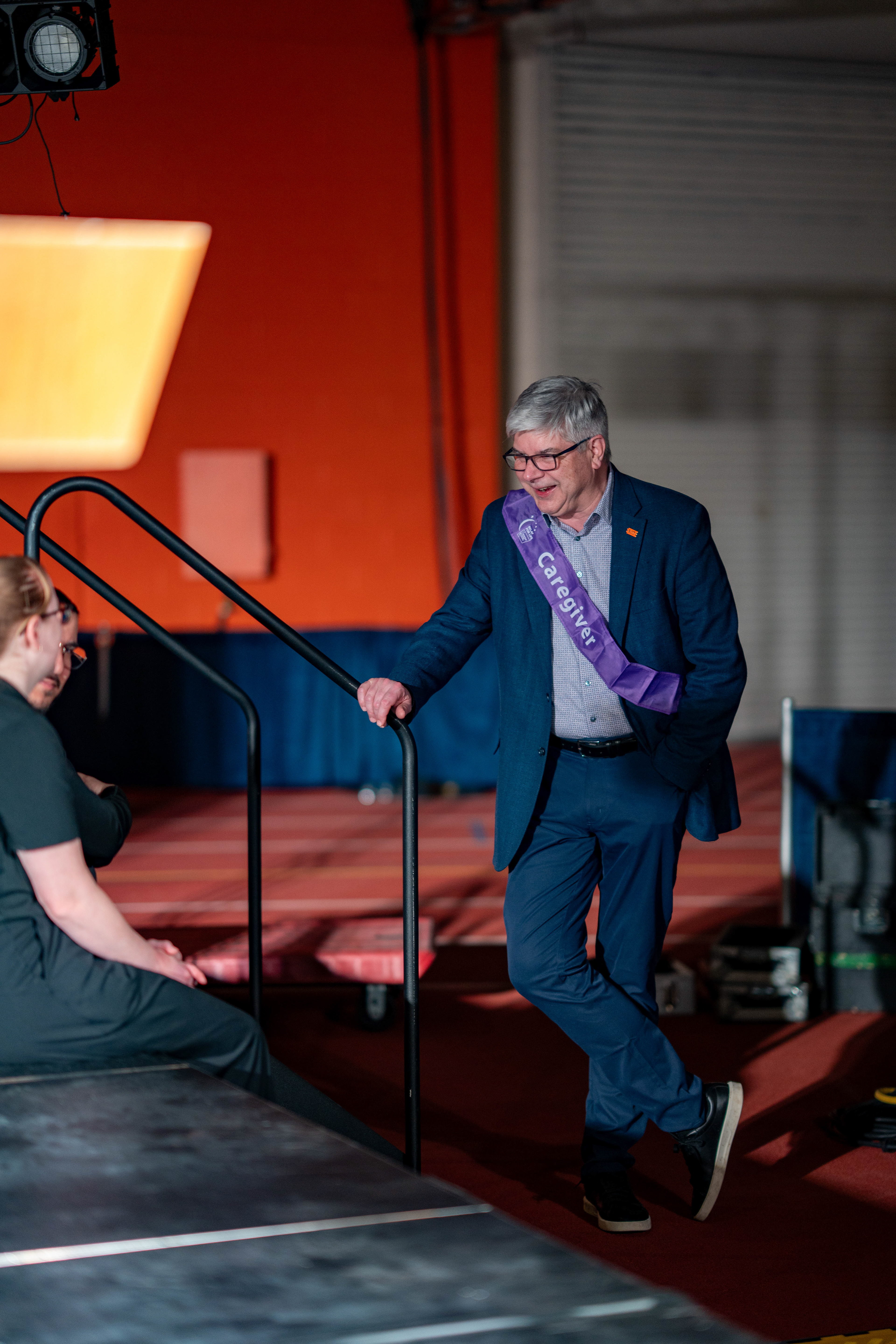 RIT President William H. Sanders, wearing a caregiver sash, chats before giving a speech during Relay For Life in the Gordon Field House at the Rochester Institute of Technology in Henrietta, N.Y., Saturday, April 11, 2026.