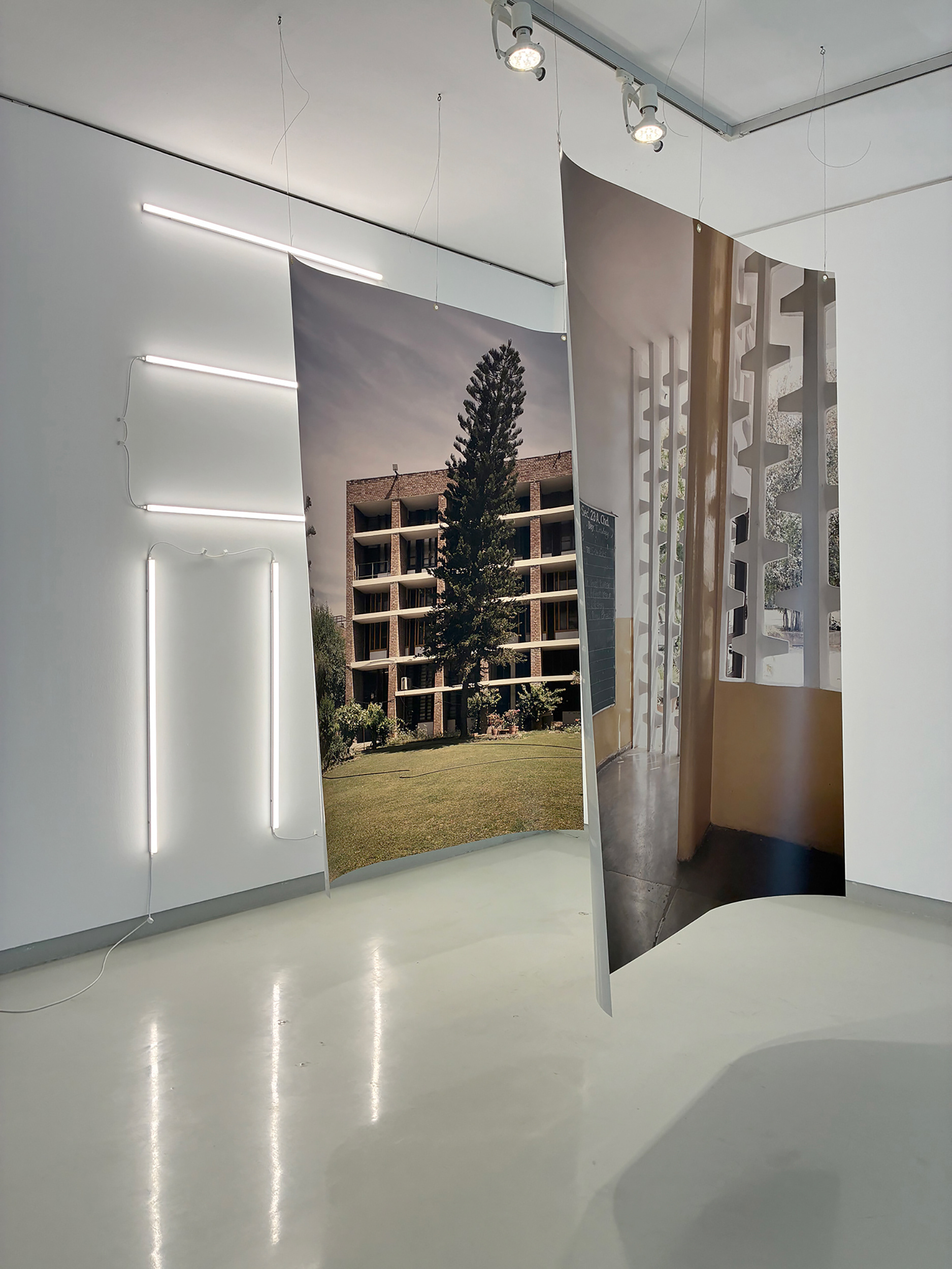 Drew/Chowdhury, 2025. Mix media installation with 2 photographic backlit prints + 6 tubular lights.  200 x 140 cm (Prints size) 257 x 140 x 230 cm (Installation). 