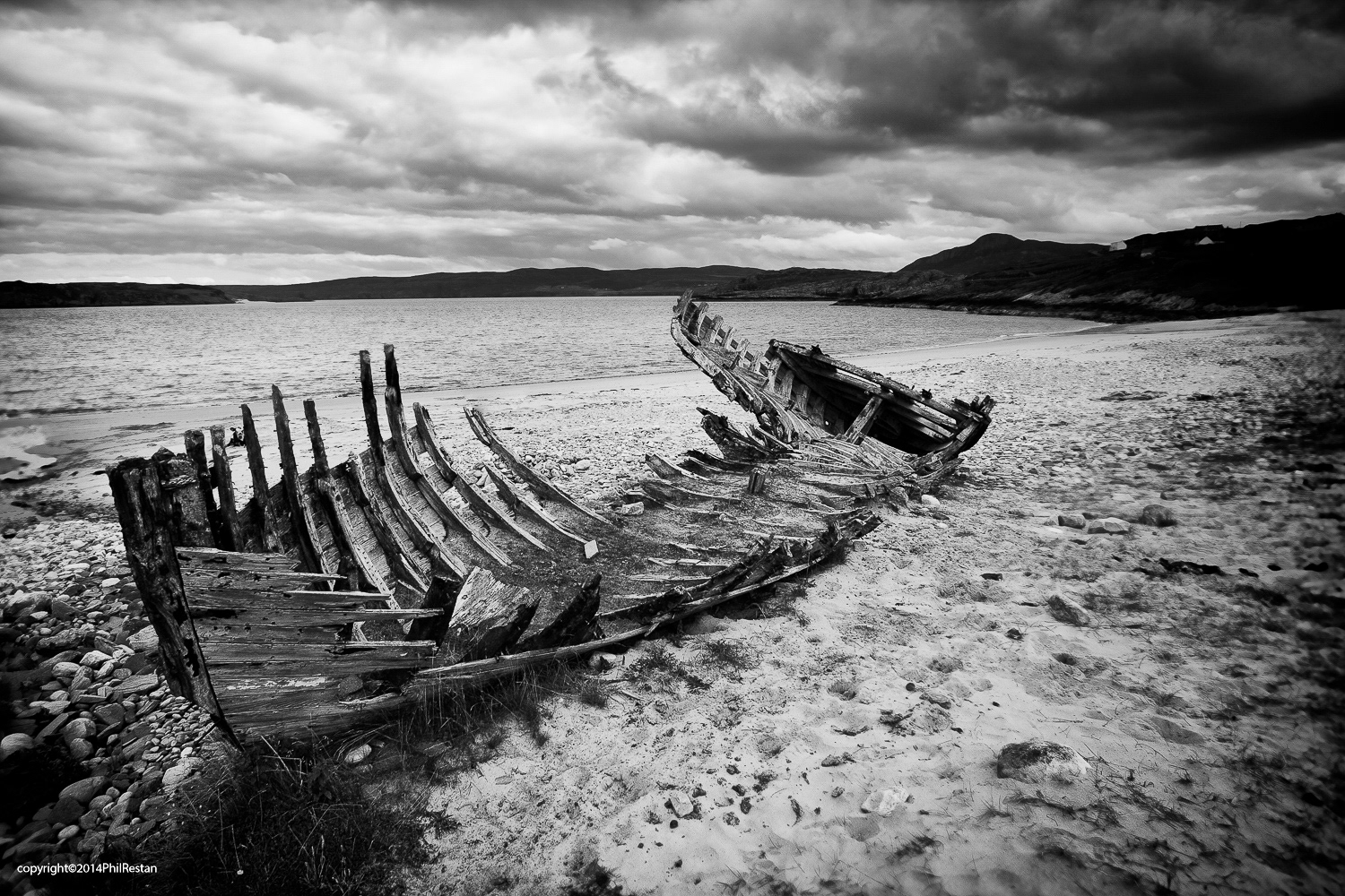 Photo of the old wooden boat wreck found on a deserted North Scottish beach