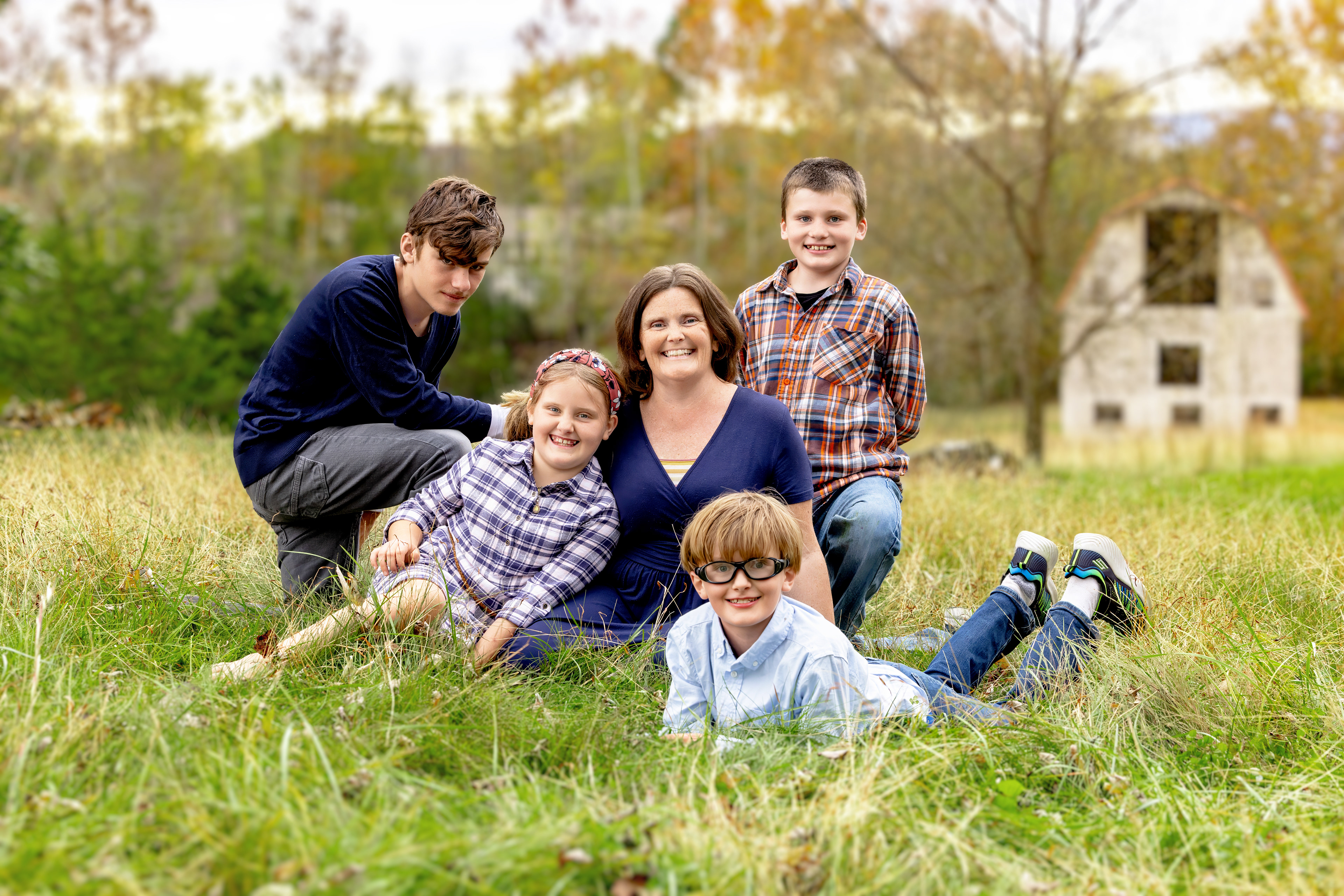 Traditionally posed picture of 4 kids with mom during a mommy and me portrait