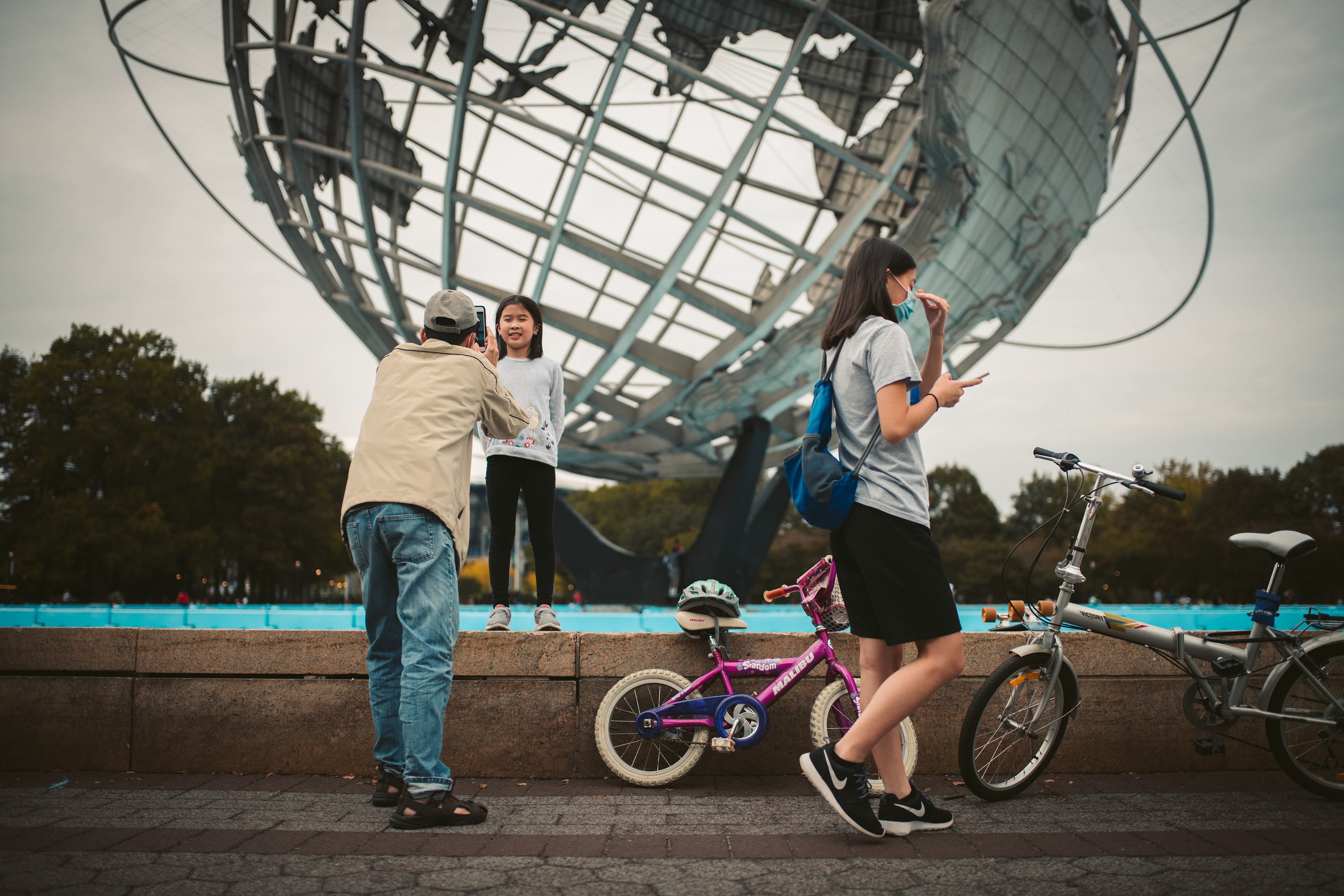 A family enjoying their time in the Unisphere in Queens, New York
