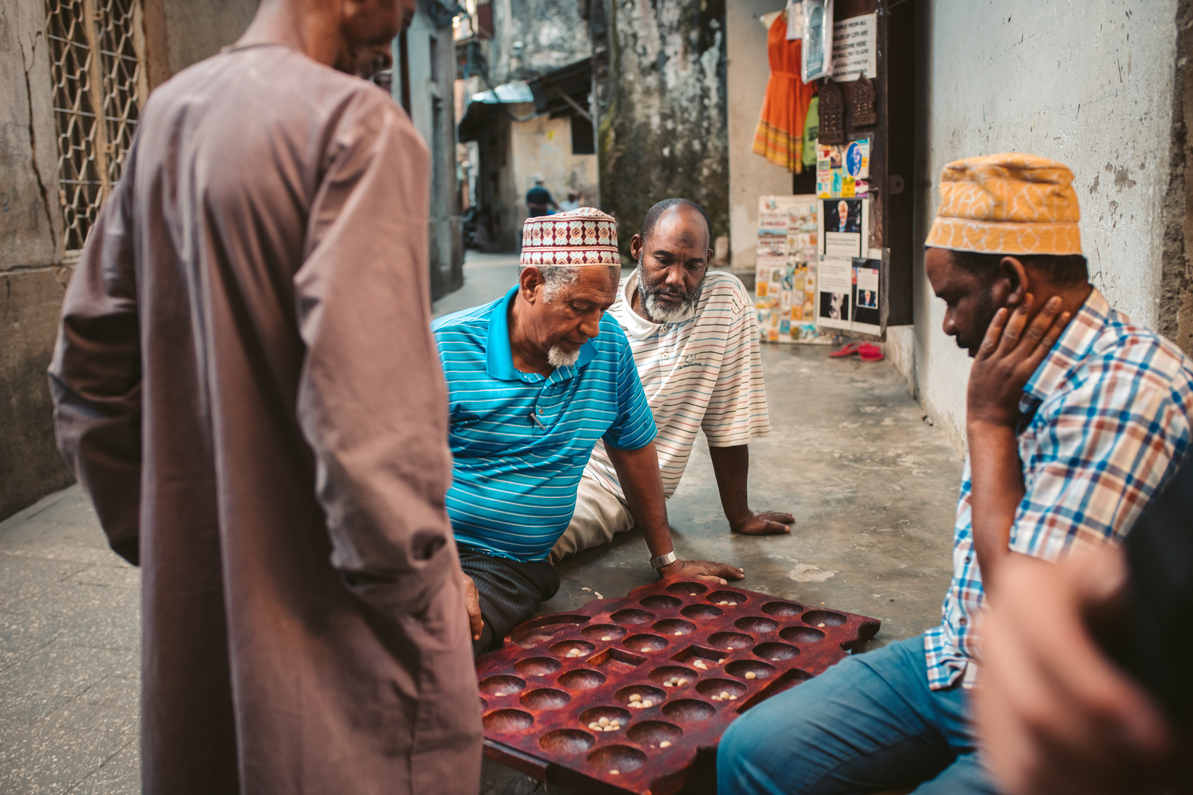 Men in Zanzibar playing mancala, a traditional board game played in East Africa